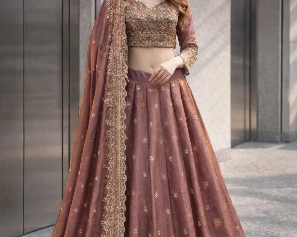 Unveil your divine elegance with the Shakti Royale Lehenga Set by AveParashakti. Crafted in rich two-tone fandy silk and adorned with heavy front-and-back sequin embroidery, this ensemble radiates power, grace, and celebration. The beautifully tailor