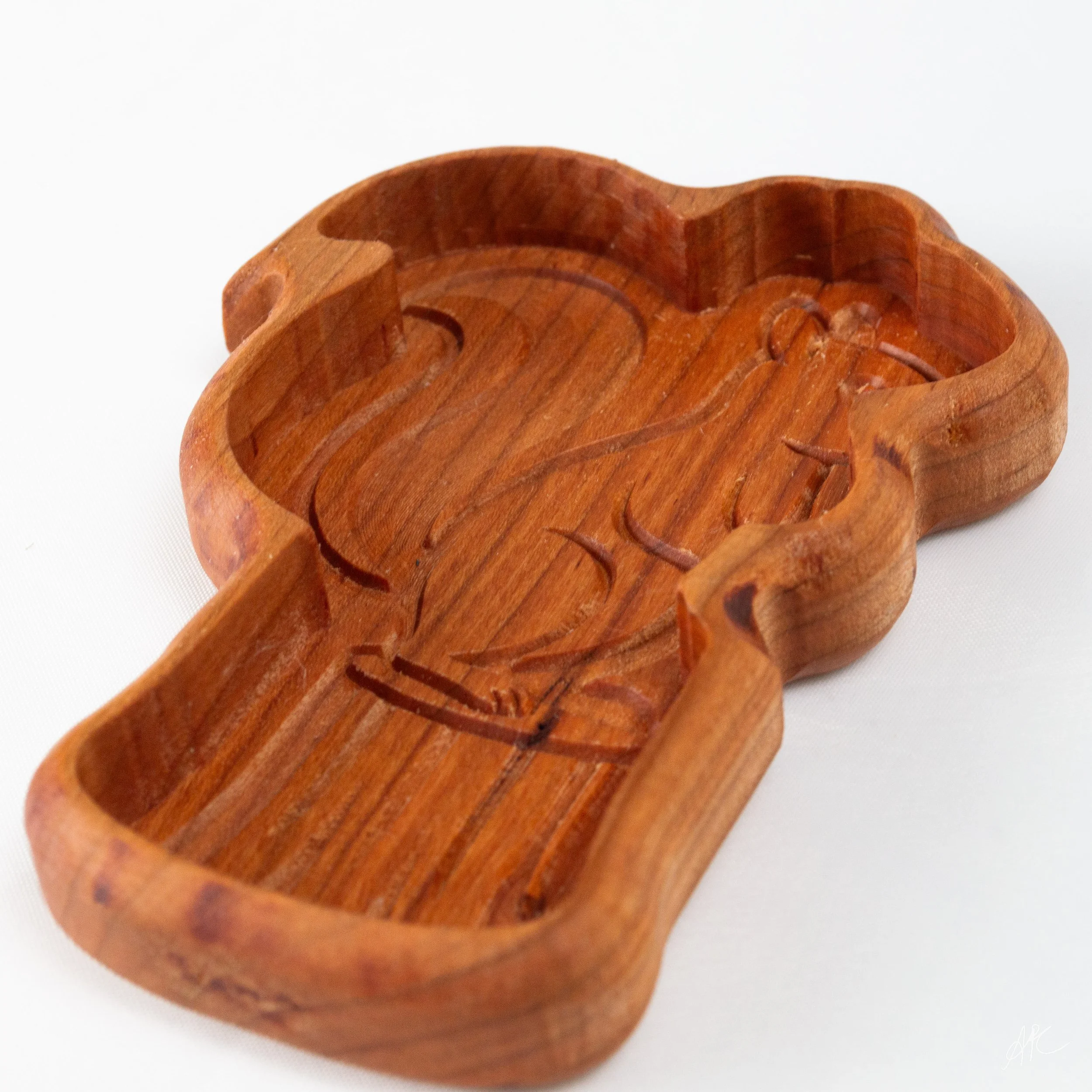 Wooden tray with carved out design of a dolphin and a palm tree