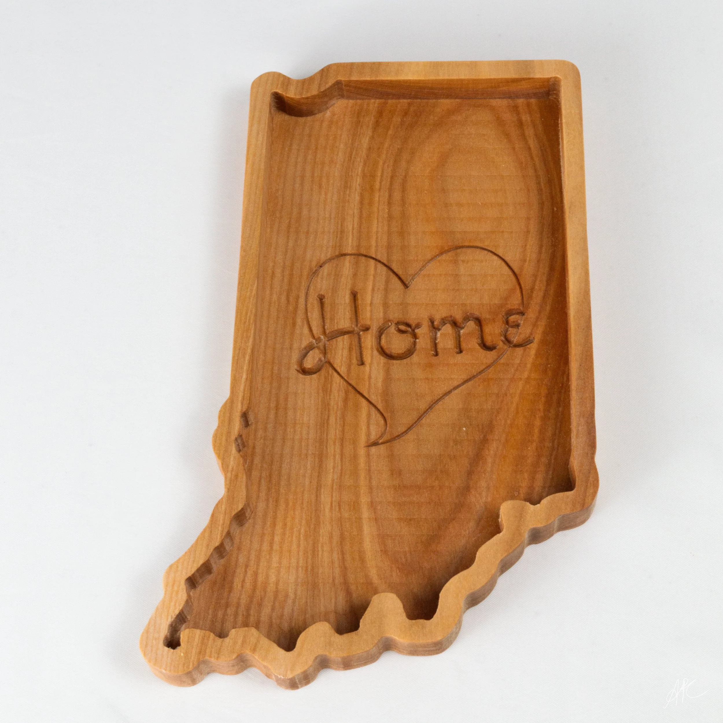 Wooden tray in the shape of the state of Indiana with the word 'Home' engraved inside a heart.