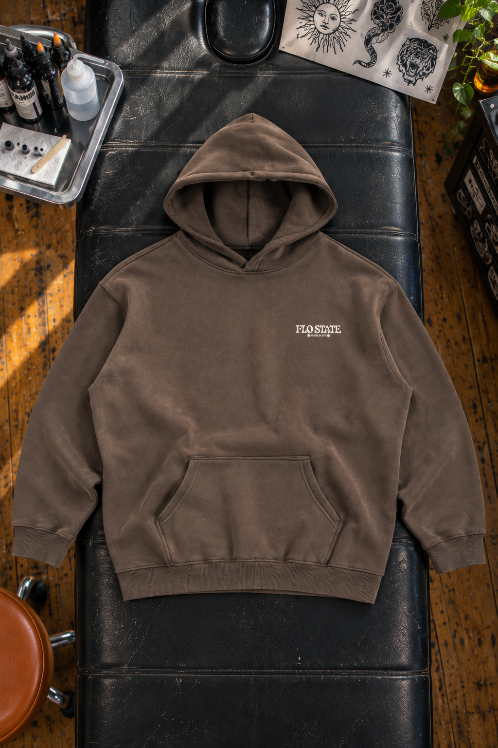 Muted brown hoodie on tattoo table.png