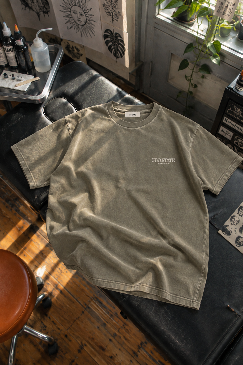 Olive STVNS tee on tattoo bed.png