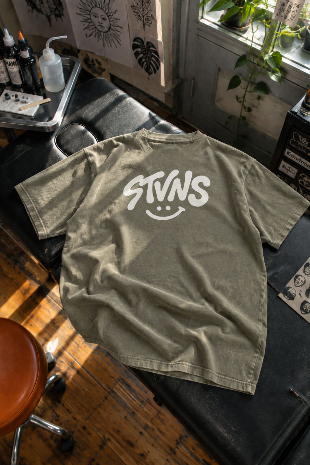 Sage STVNS back tee on tattoo bed.png