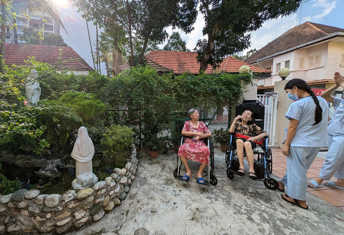 A caregiver assisting an elderly patient, representing Community Care and Support Services training.