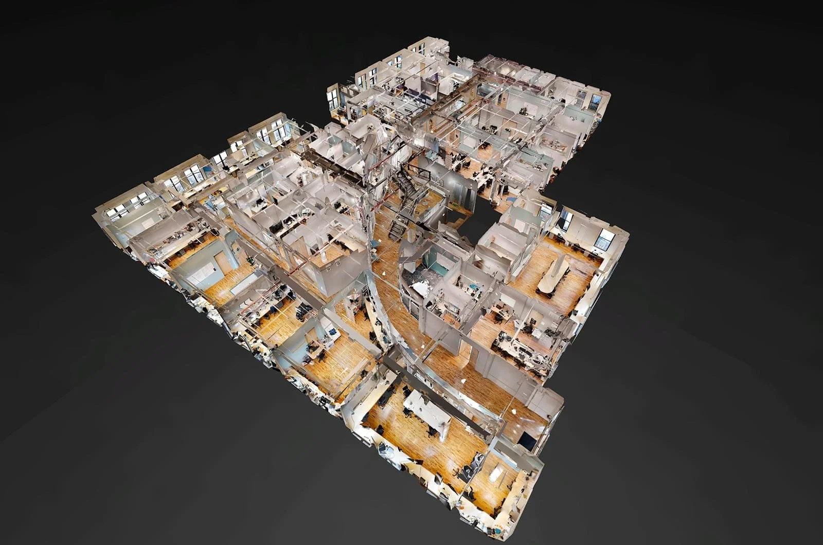 3D floor plan of an office with multiple rooms, desks, conference rooms, and communal areas.