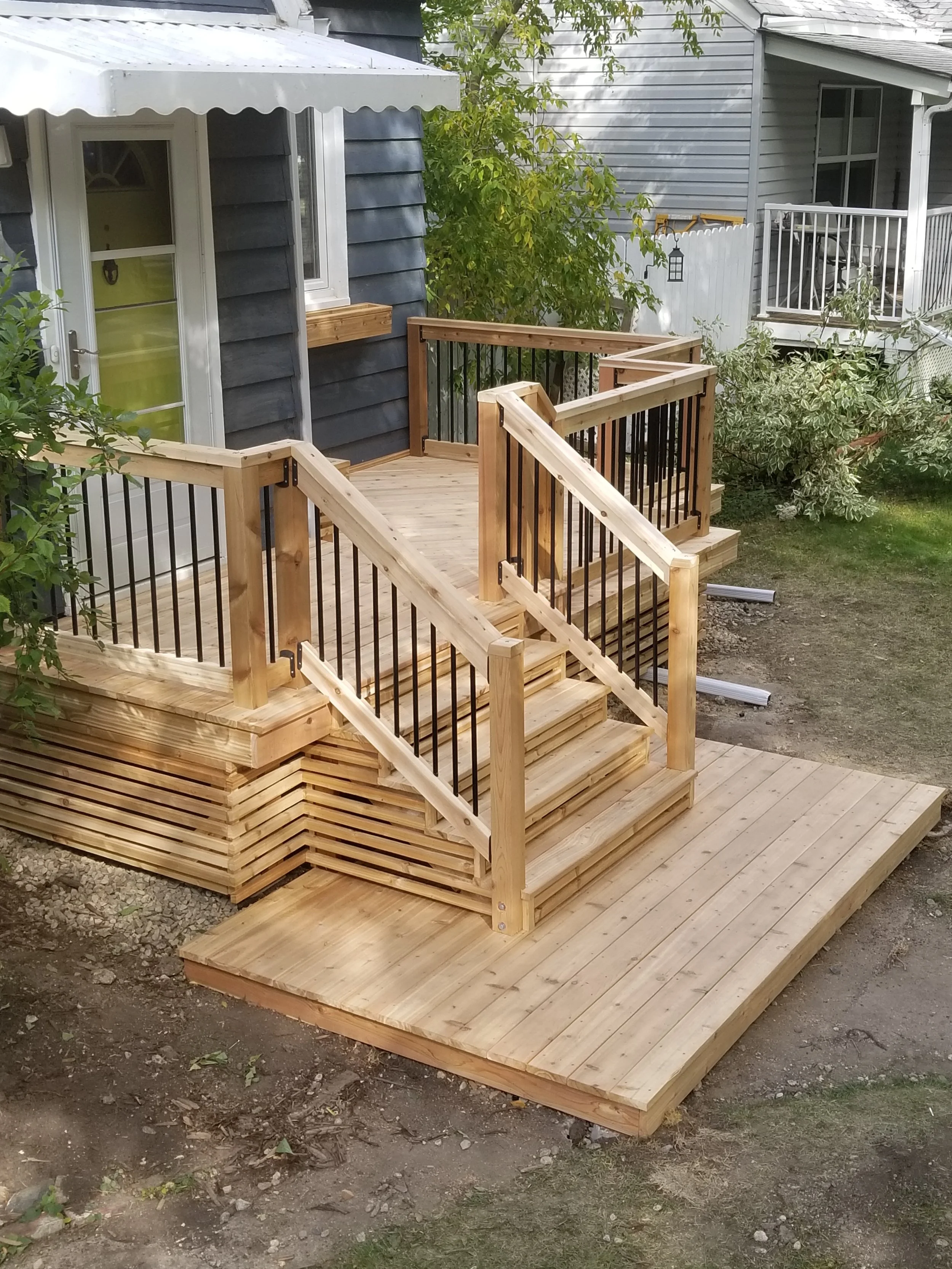 Custom Cedar deck with metal balusters and horizontal skirting