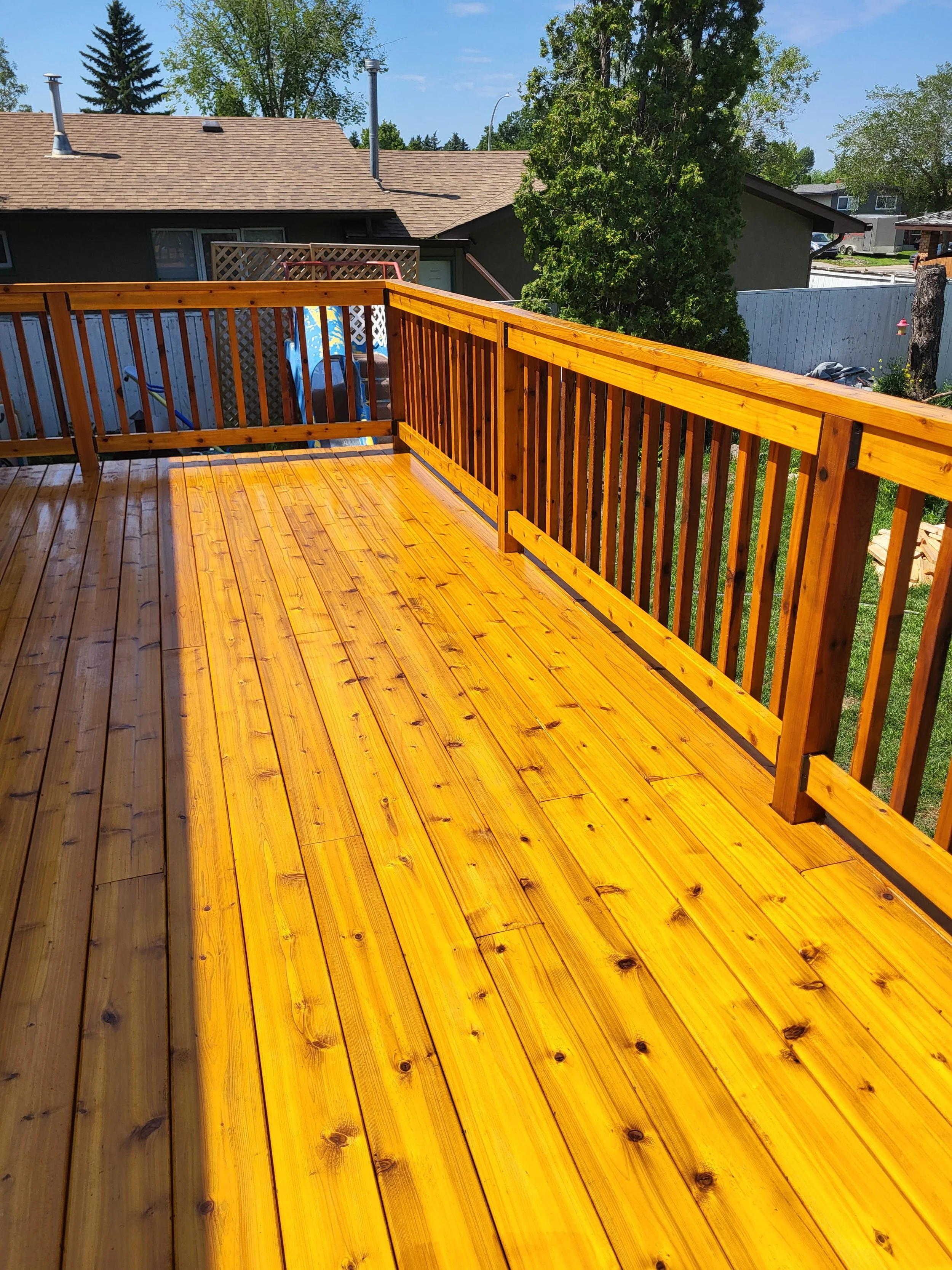 Hand finished outdoor carpentry. A beautiful cedar deck shining in the sun with Sikkens Prolux Finish.