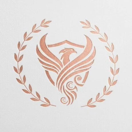 A rose gold emblem featuring a stylized phoenix with spread wings, surrounded by a laurel wreath.