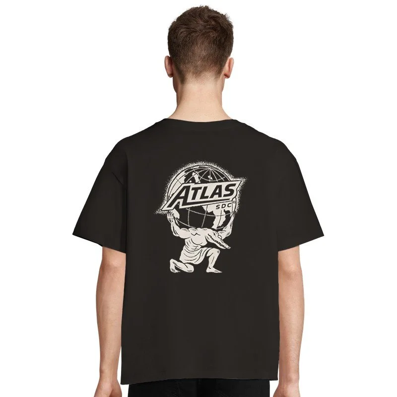 Jeune homme portant un t-shirt noir avec un logo ATLASSOC sur le dos, représentant une figure musculaire soutenant un globe terrestre