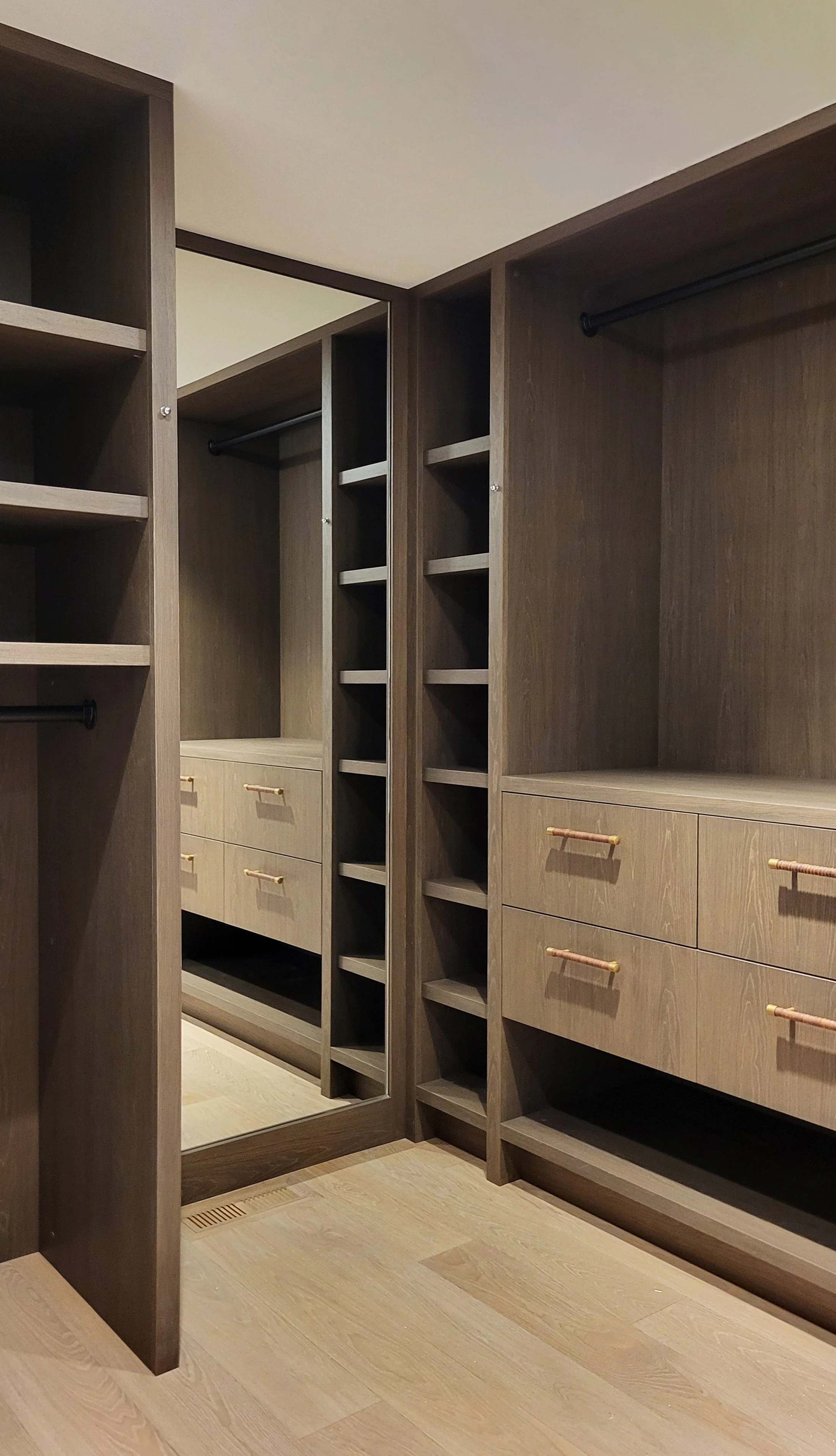 Open jewelry drawer containing watches, rings, necklaces, and bracelets organized in dividers.
