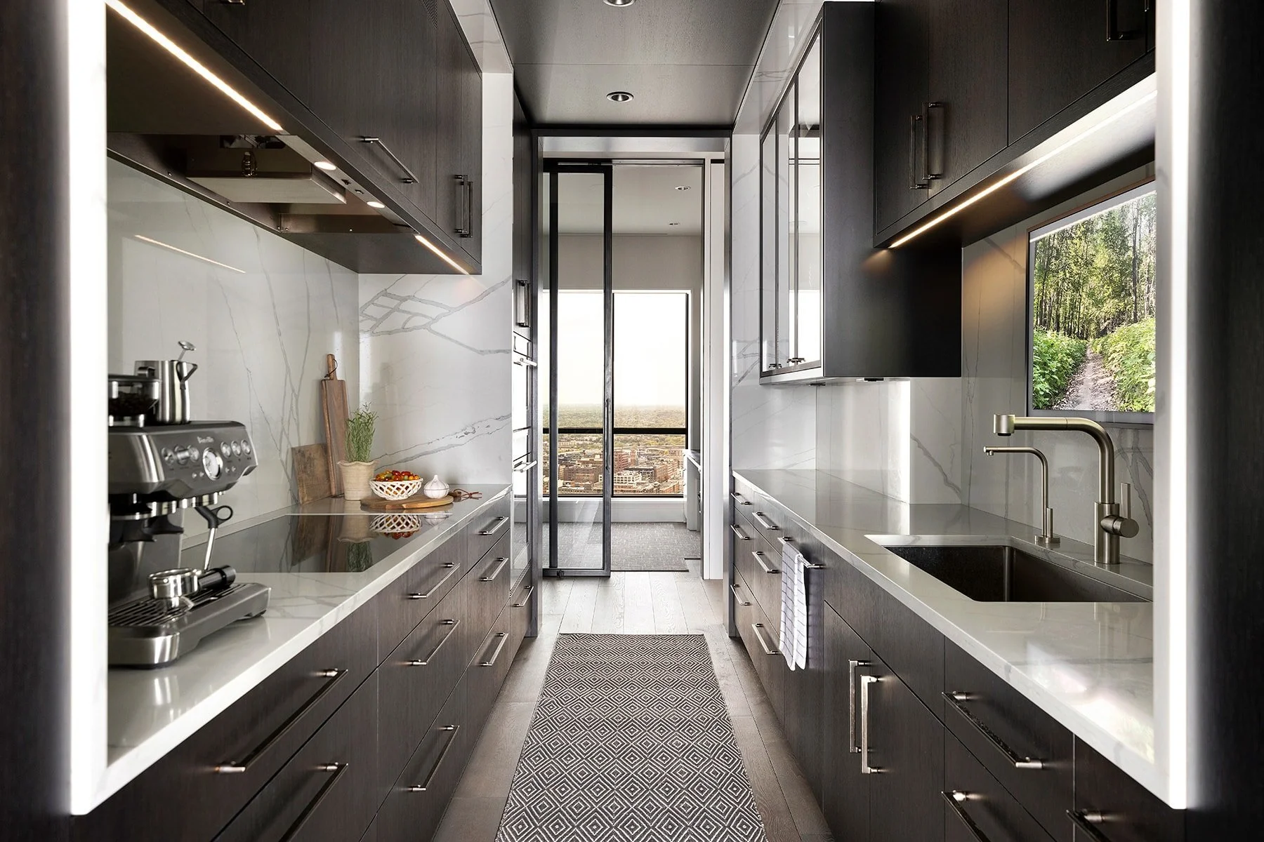 Modern kitchen with dark wood cabinetry, white marble countertops and backsplash, stainless steel appliances, and a view of a green outdoor path through the window.