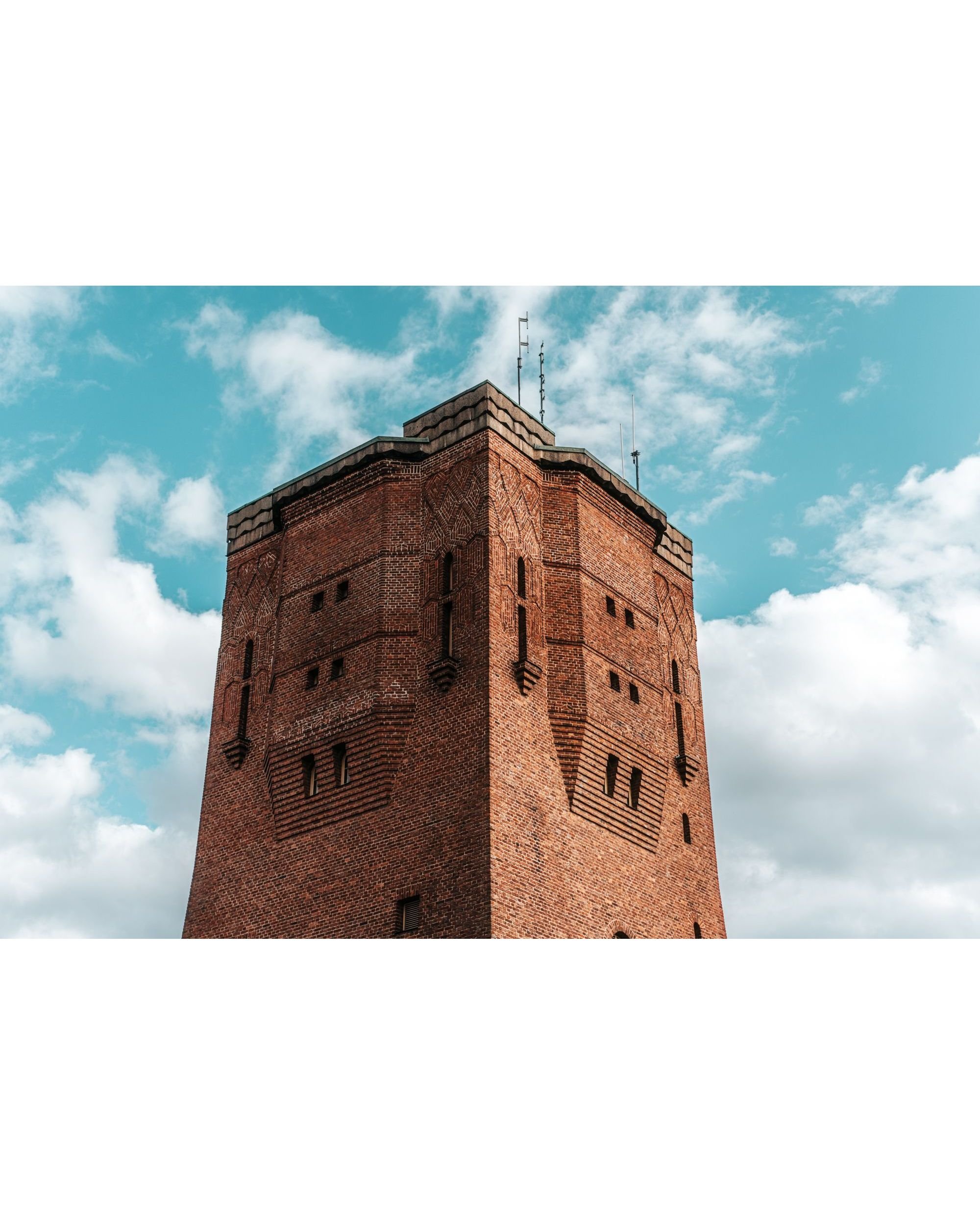 Sundbyberg water tower against a bright blue sky with clouds on a summer afternoon, fine art cityscape photography print