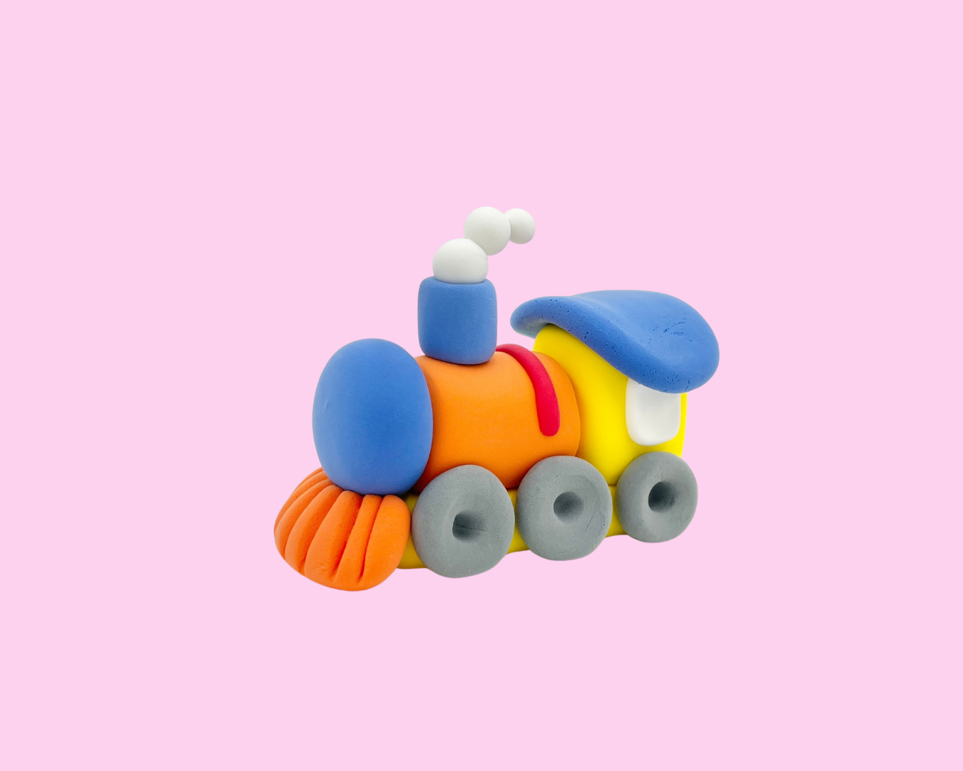 Colorful playdough train with multiple carriages on a pink background.