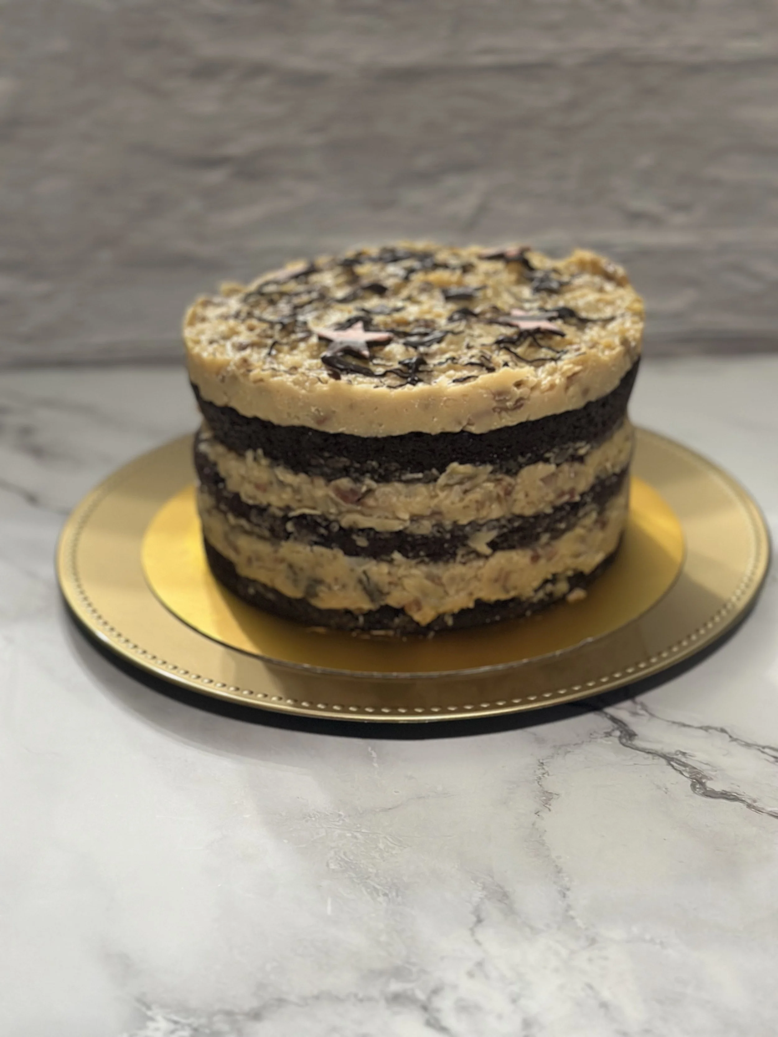 German Chocolate --- Moist chocolate cake with a rich coconut-pecan frosting