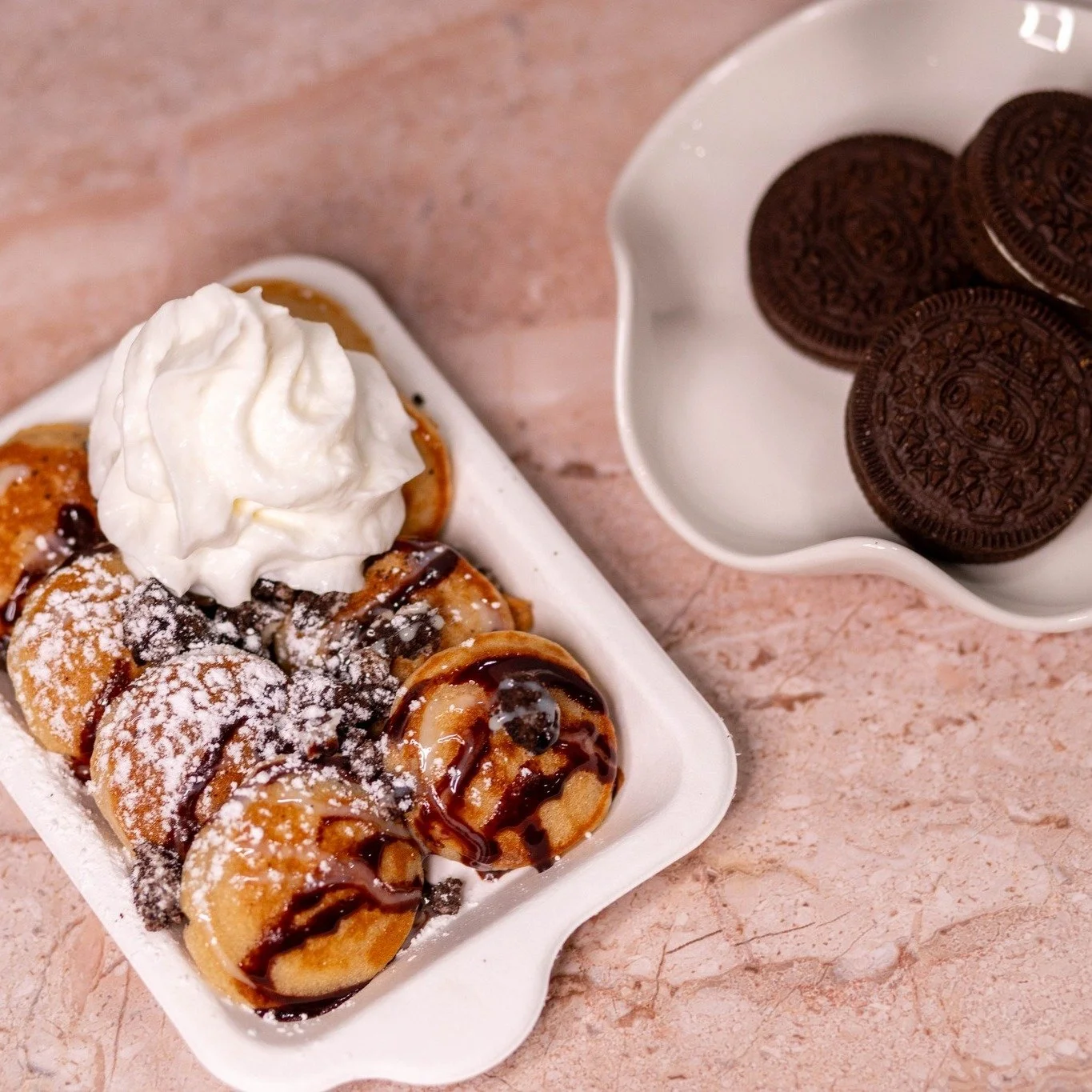 Friday called. It wants mini pancakes. 🥞✨
 
Fluffy mini pancakes &mdash; loaded with your choice of toppings, fruits, and drizzles. Plus condensed milk, whipped cream, and powdered sugar on deck.
 
We're talking Biscoff crumble, pistachio cream, kat