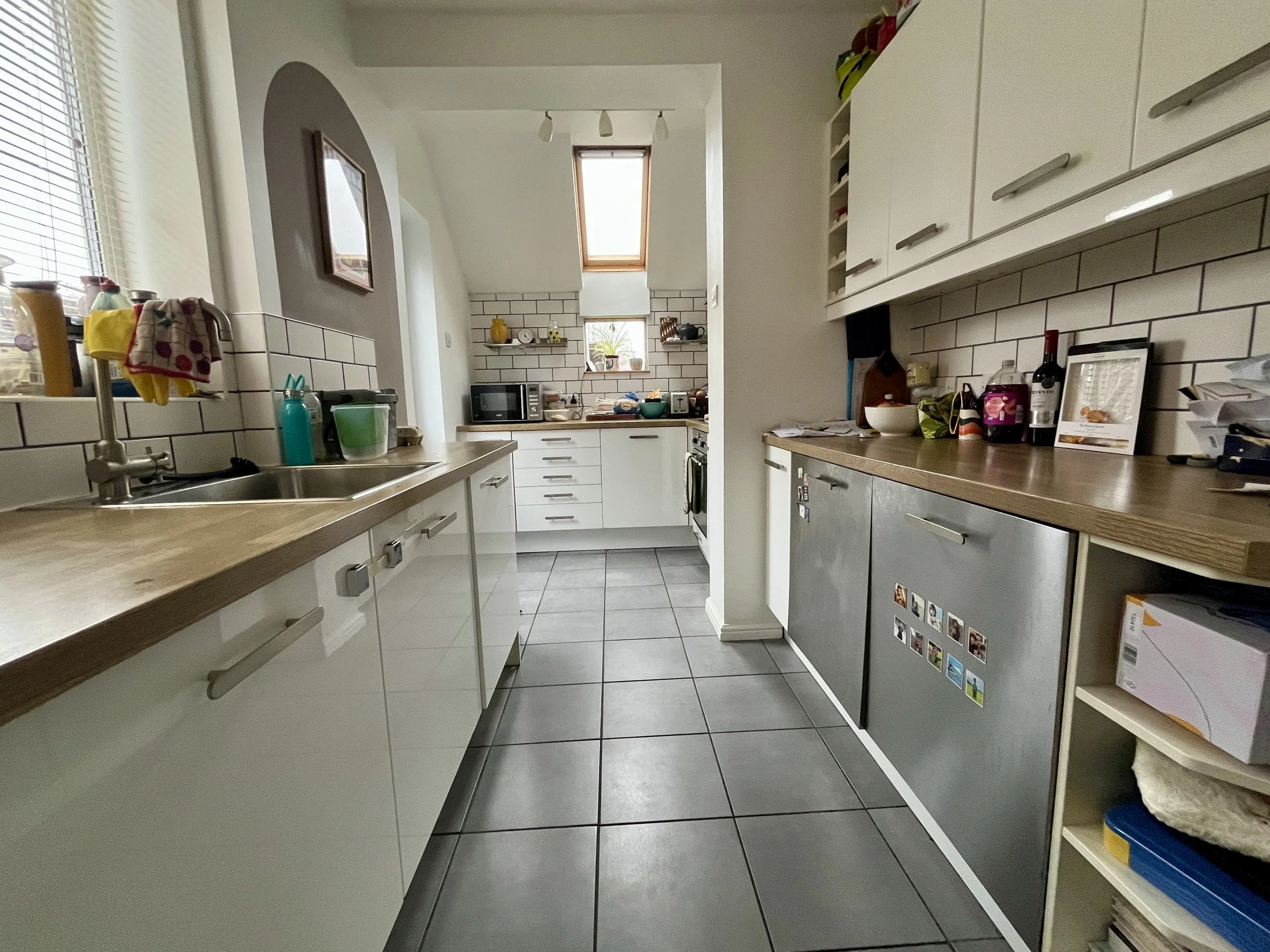 Please take a clear, wide-angle photo showing the entire kitchen from one side. Make sure the image captures all cabinets, counters, and any islands, so we get a full sense of the layout and space. Natural lighting helps
