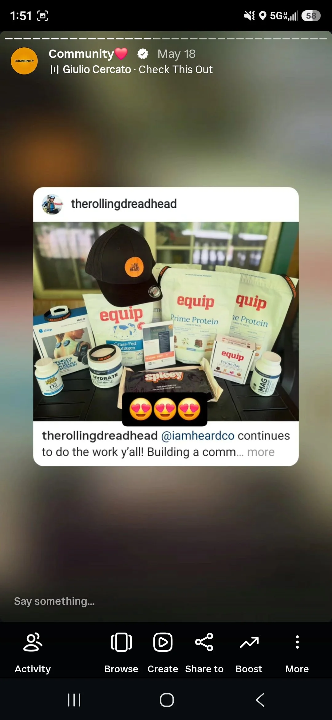 A cluttered table with cardboard boxes, a white bottle of electrolyte powder, various snack packages including Heavey Naturals organic snacks and Keto Brainz Nootropic powder, wristbands, and handwritten notes.