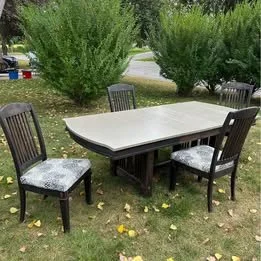 Refurbished mission-style dining table with four slat-back chairs featuring upholstered seats