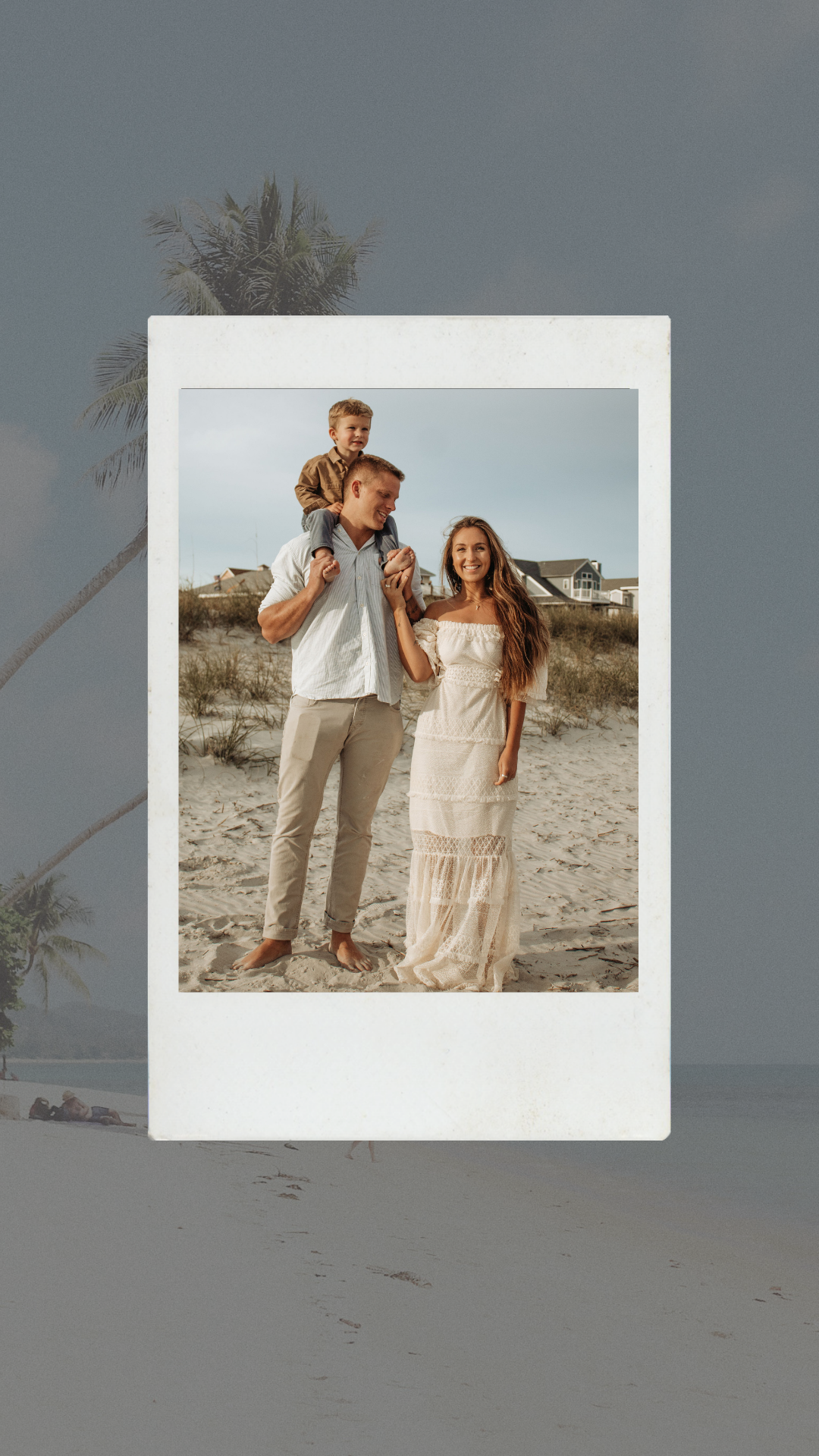A family of three on a beach, with a man carrying a young boy on his shoulders and a woman standing beside them, all smiling.