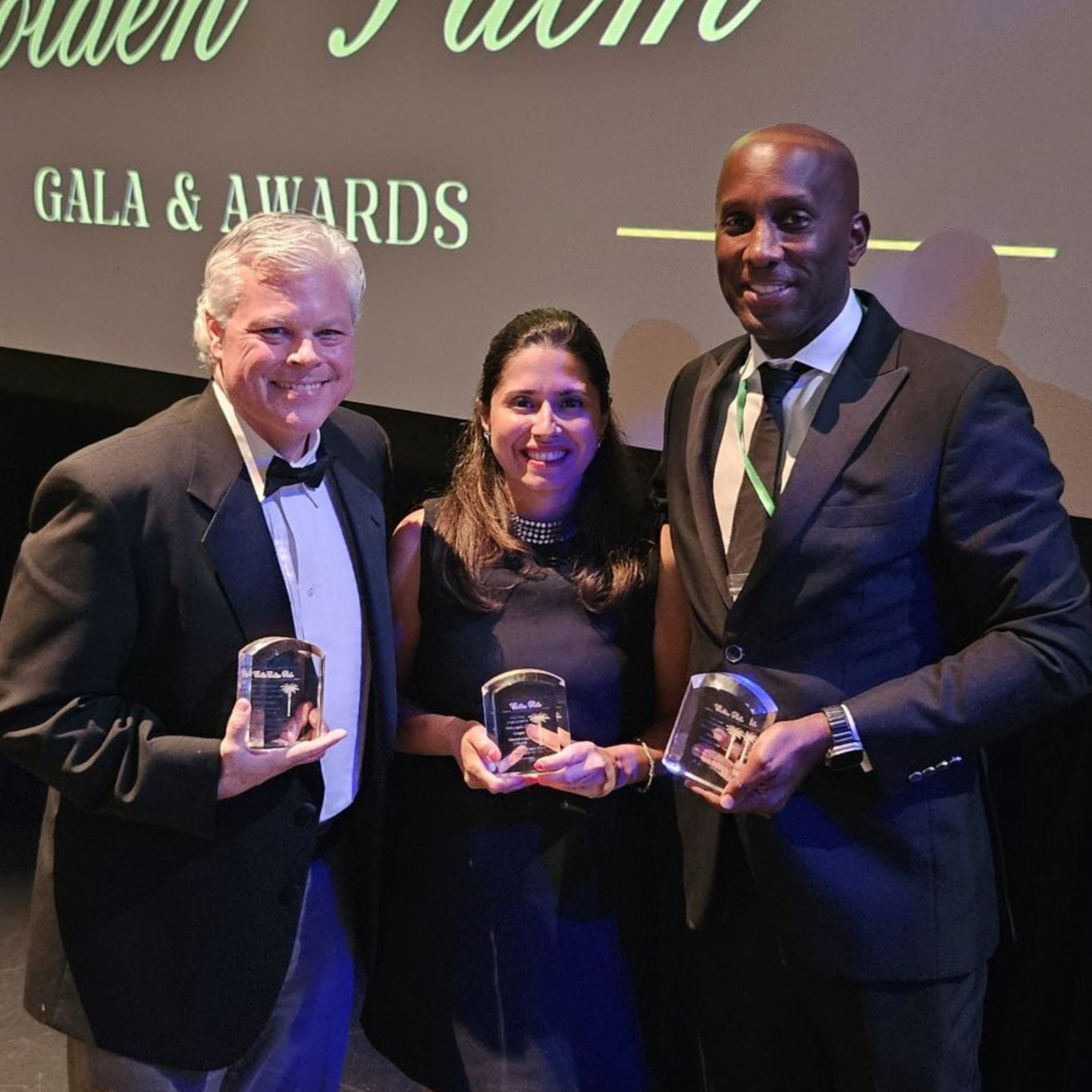 3 people displaying their awards at the Gold Coast Gala