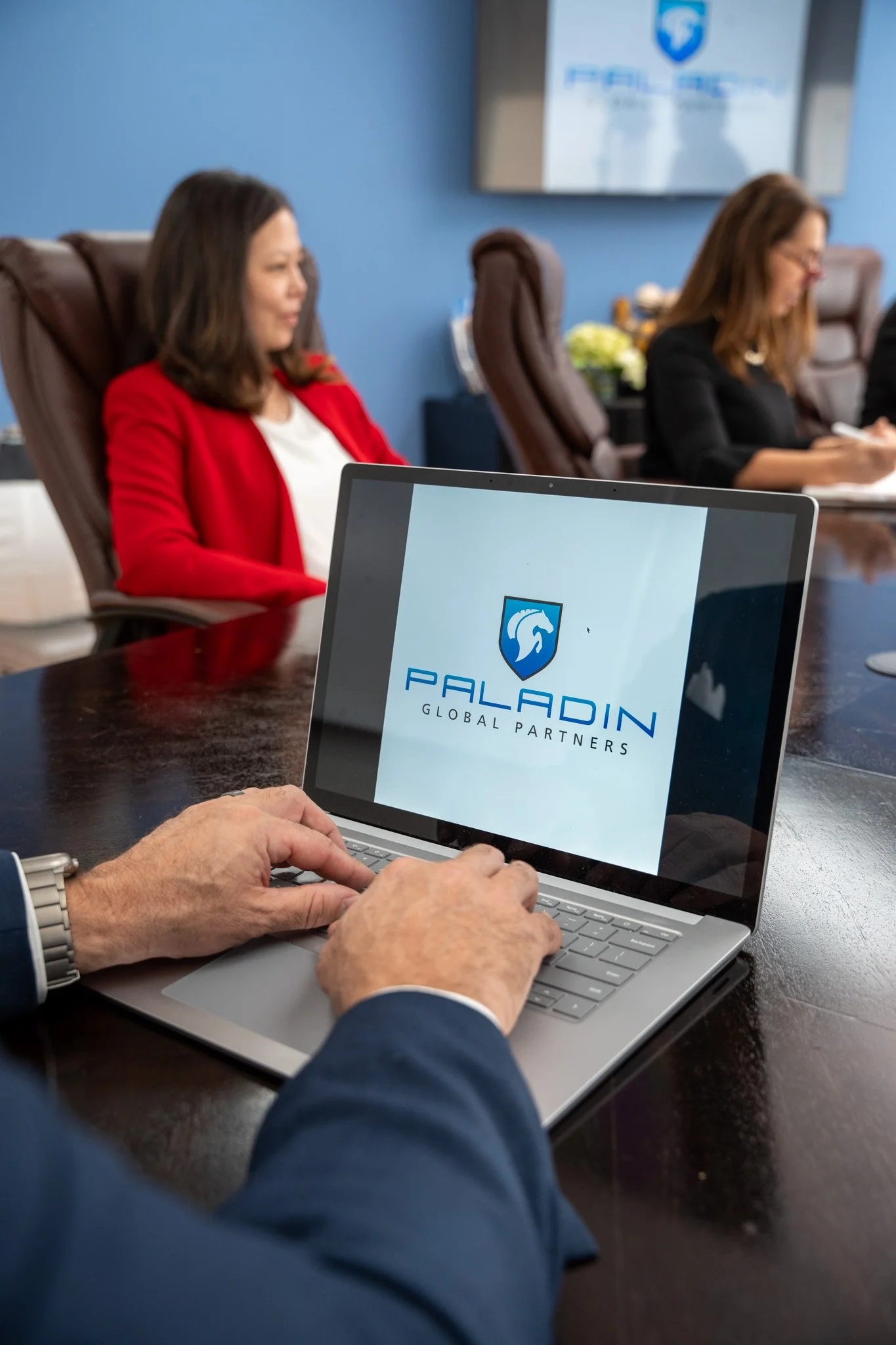 Person on Laptop Showing Palladin Logo