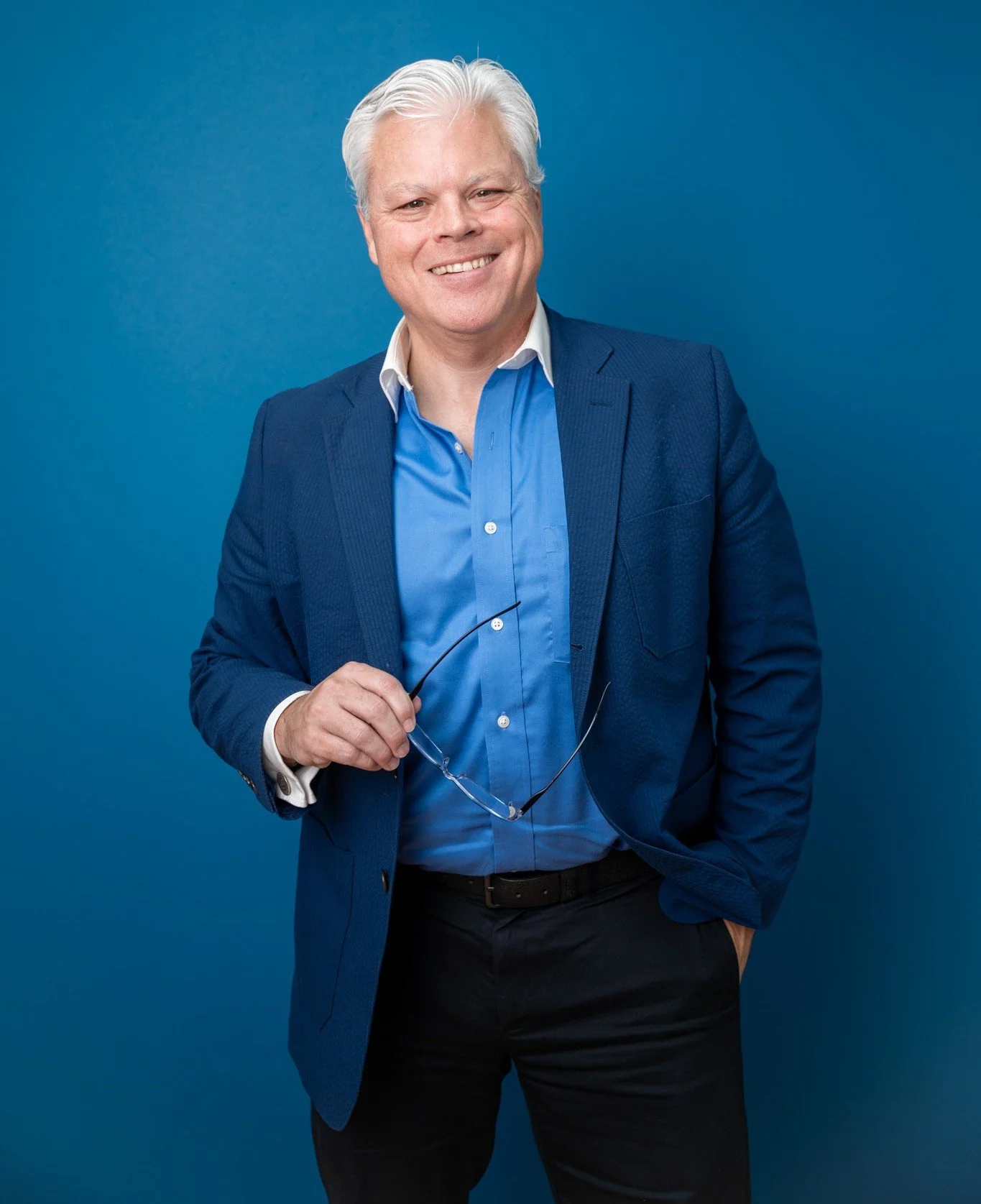 Photo of Bo Megginson holding his glasses in his hand