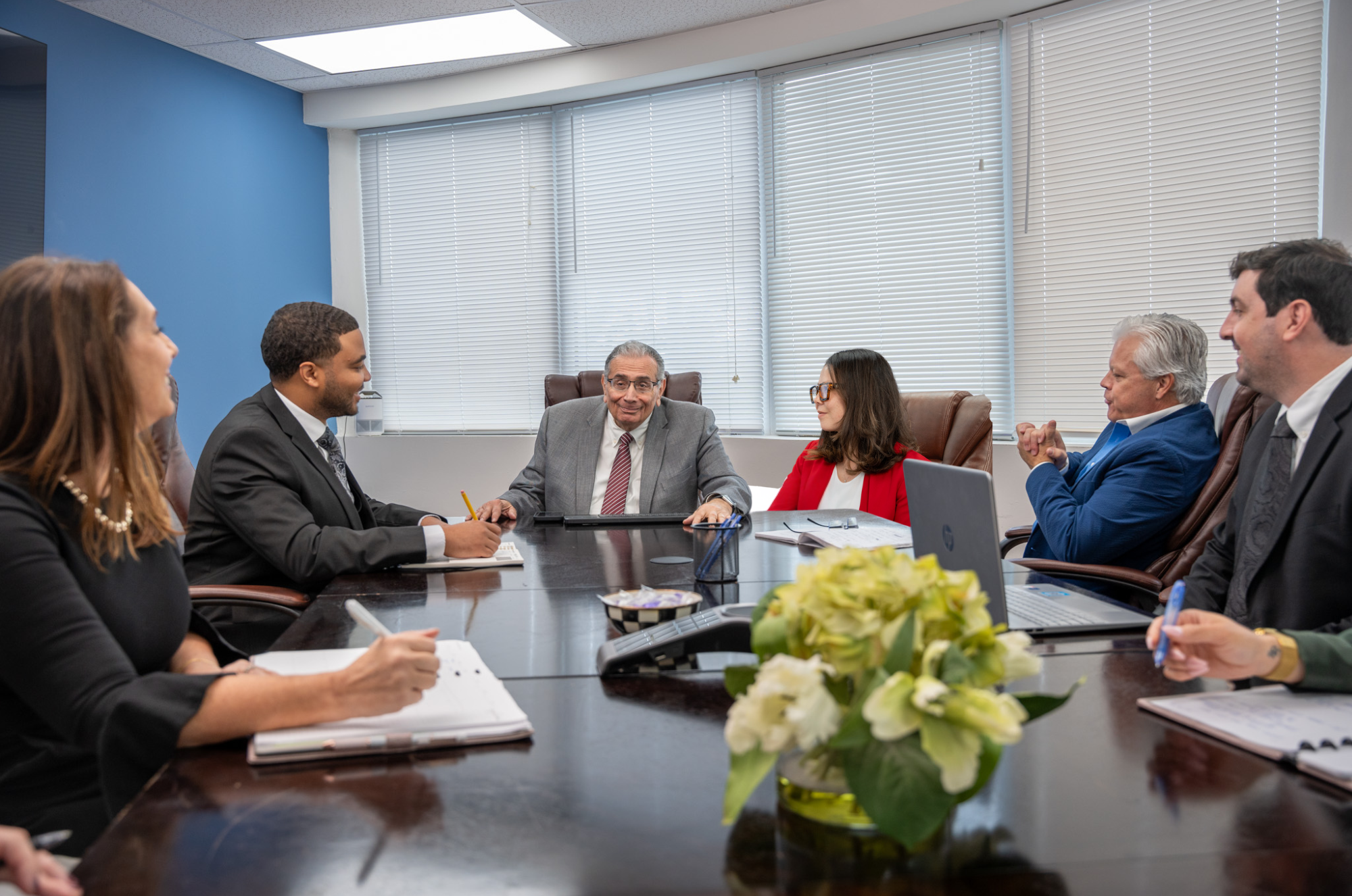 Photo of the Team Sitting at Round Table