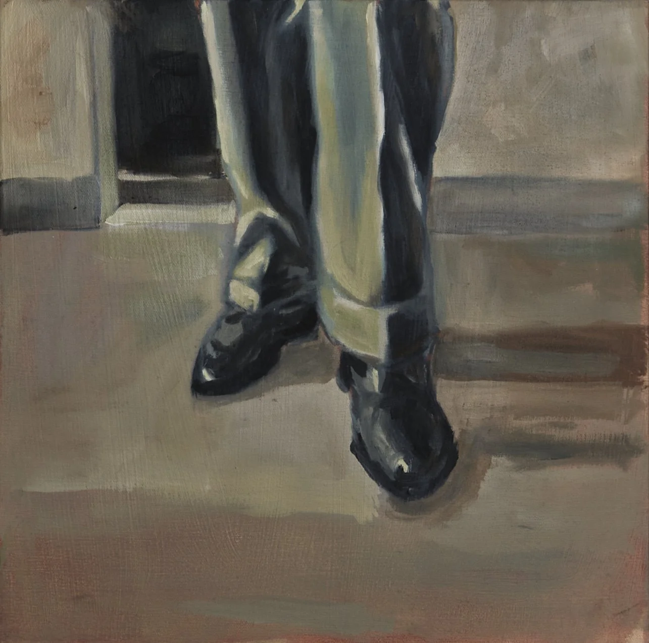 Pies de una persona con zapatos negros y pantalones claros, caminando por un pasillo de una estructura de concreto o piedra.