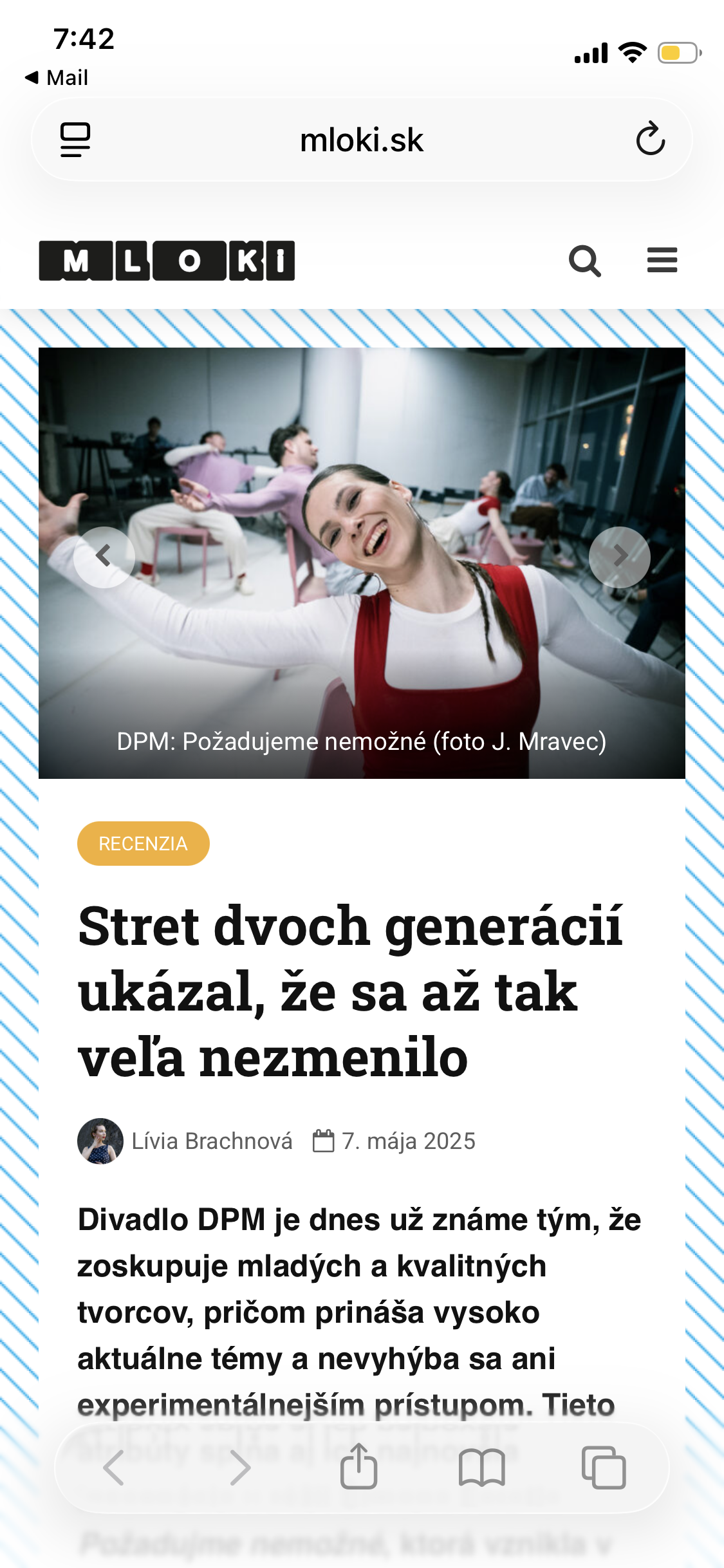 A woman in a red and white costume smiling with her arms outstretched, others sitting in the background in a room with large windows, engaged in activities, possibly rehearsing or performing.