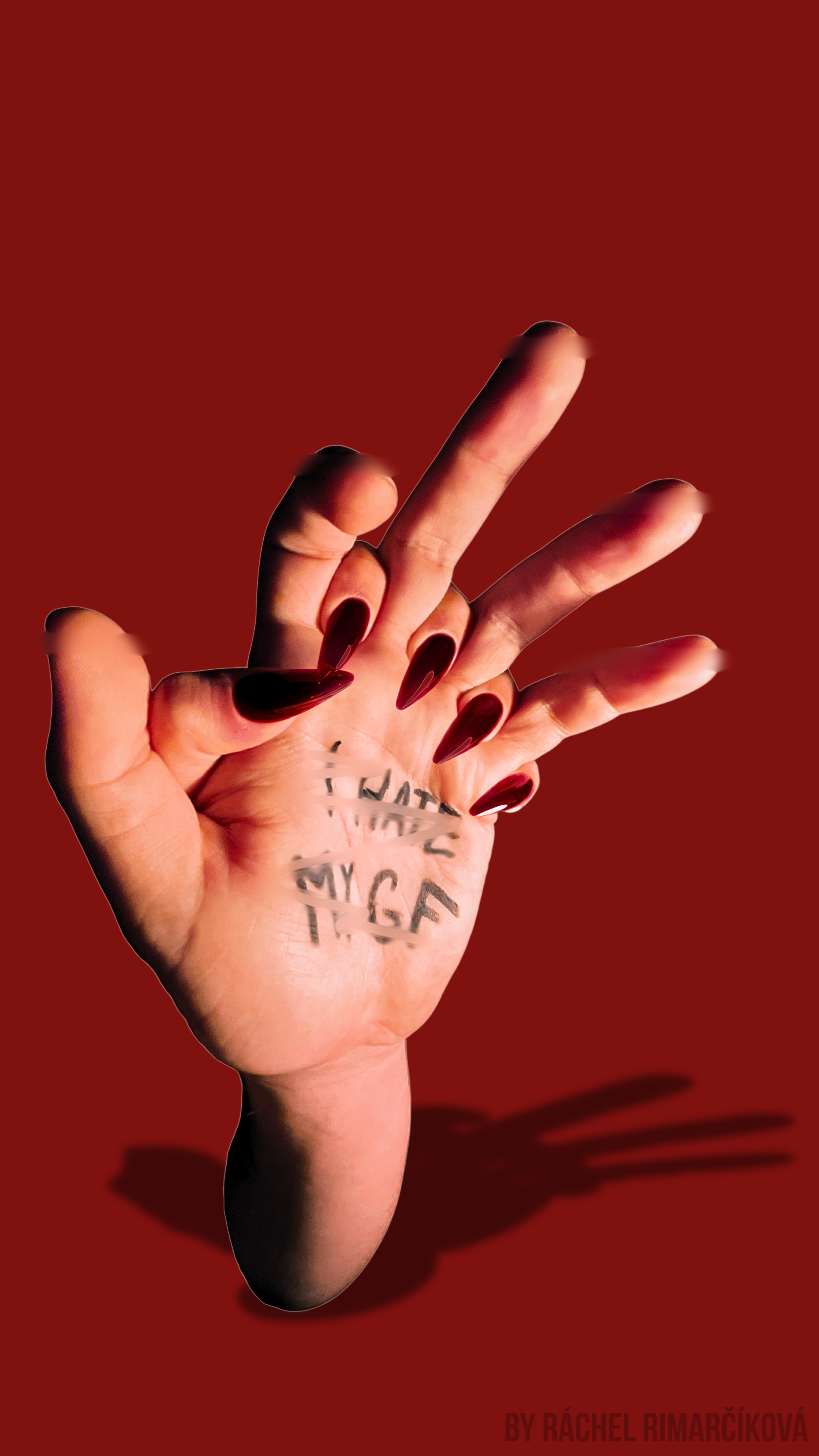 A hand with dark red nails making a gesture with the middle finger extended and the thumb, index, and pinky fingers curled. The hand has black ink writing on the palm that says, "MY G F" with some letters blurred. The background is solid red, and there is a shadow of the hand cast on the surface below.