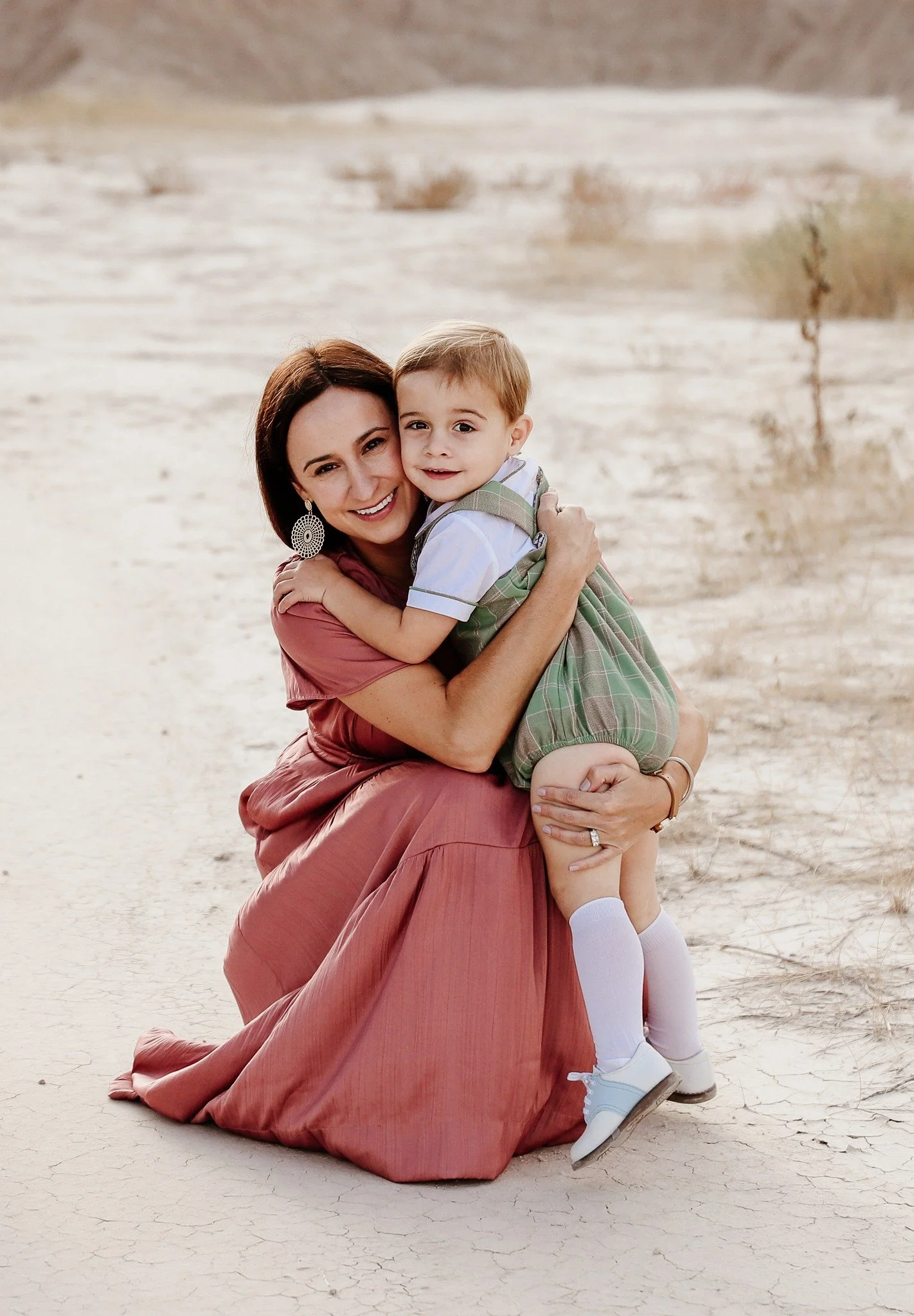 Rapid City, South Dakota motherhood photographer, mother and child in Badlands National Park hugging during golden hour