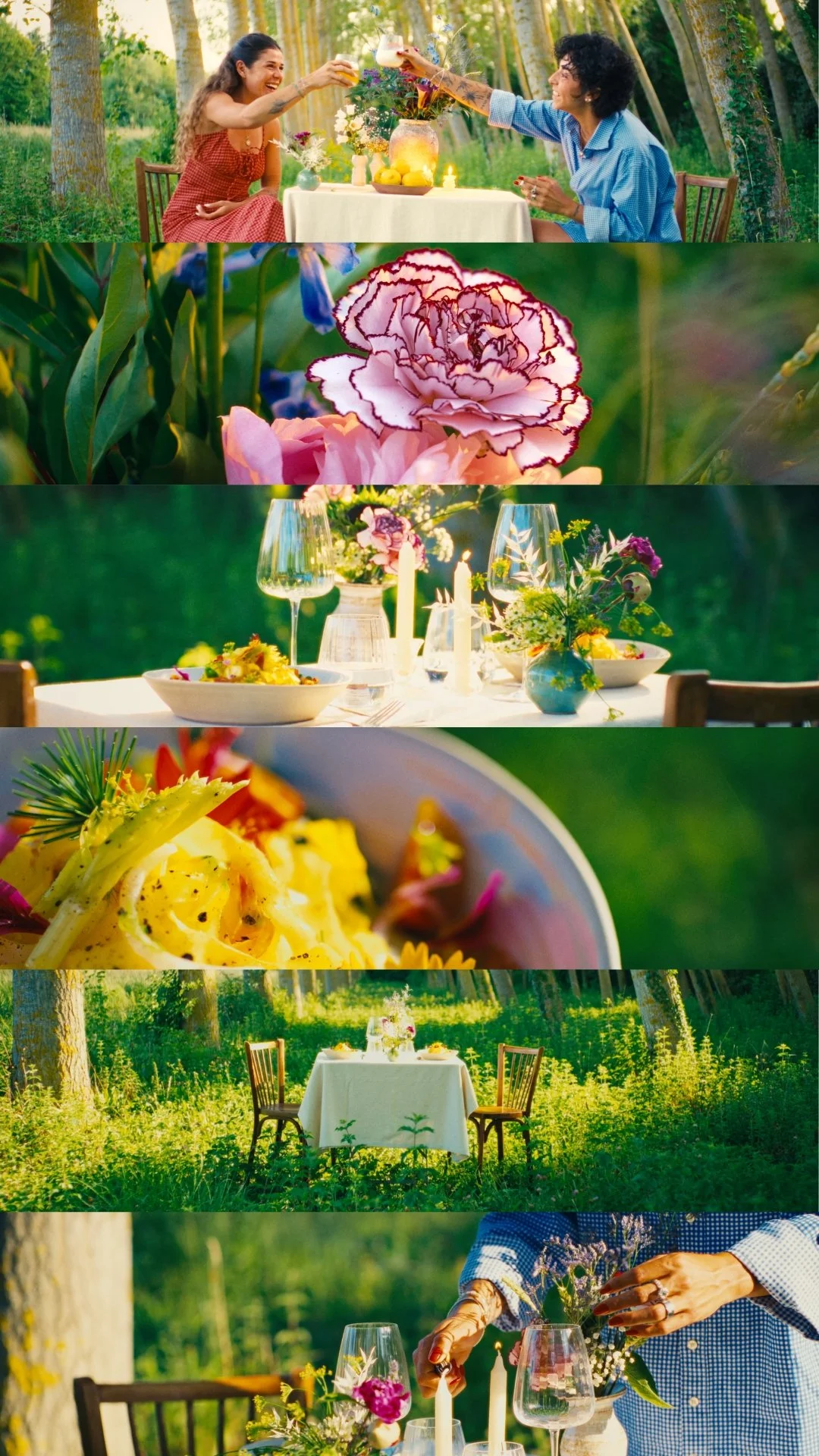 A gathering of people enjoying a meal outdoors in a lush, green forest setting with a decorated table, flowers, candles, and food, capturing a joyful, nature-inspired celebration.