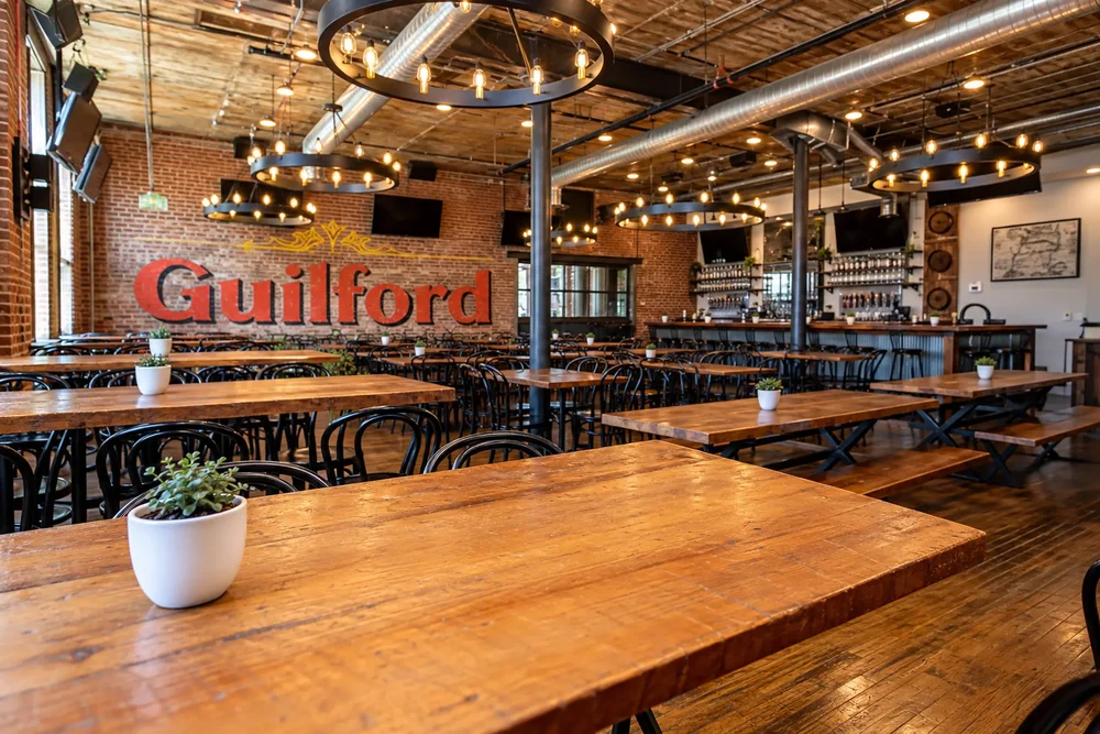 The beer hall at Guilford Hall with long wooden tables