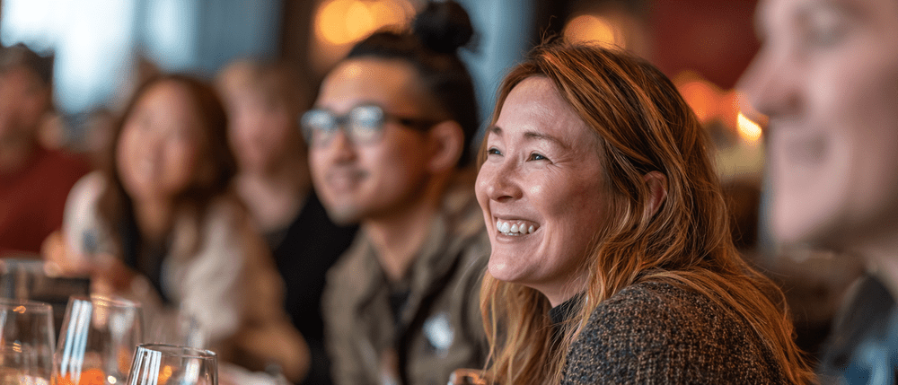 A company team gathered for a private lunch in a warm venue space