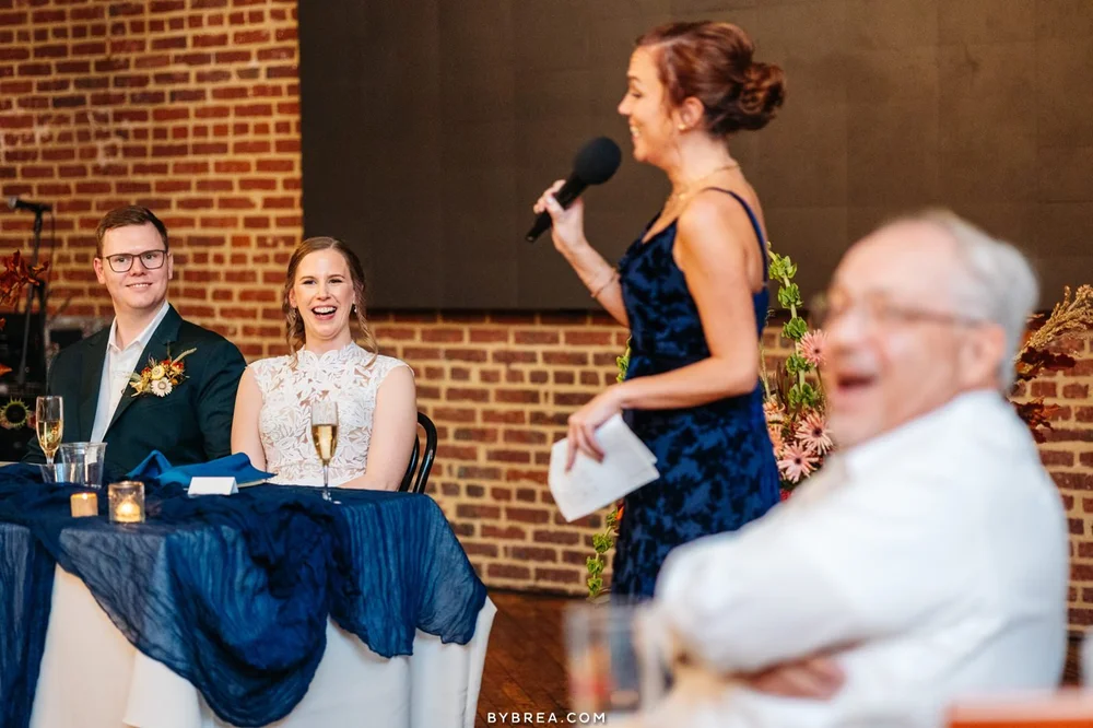 A guest giving a toast with a microphone at a Guilford Hall wedding