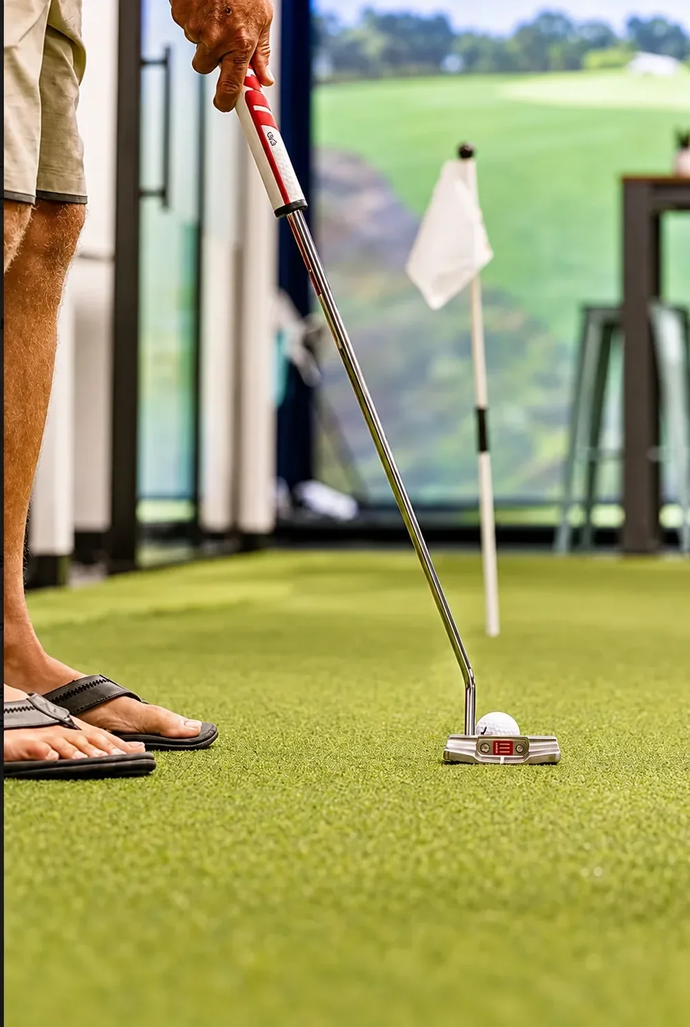 A putt rolling toward the flag on the indoor green