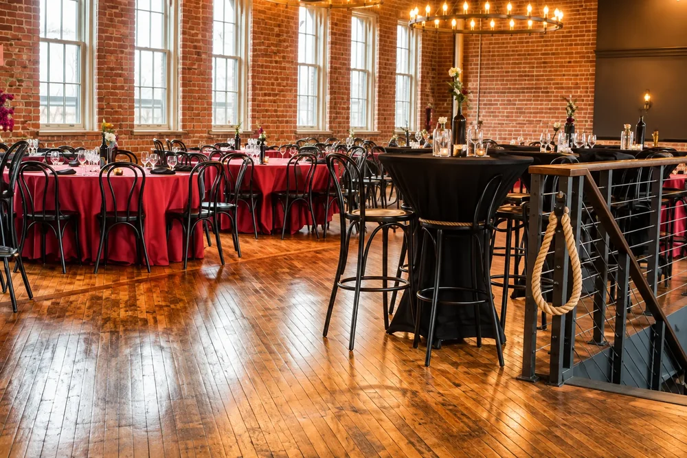 Crown Hall set for a corporate reception with red linens and high-top tables