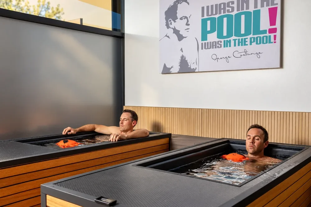 Two guests relaxing in the cold plunge tubs