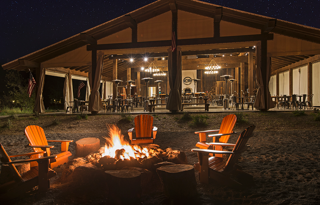 Wedding ceremony setup at Conestoga Ranch with guests facing the lake