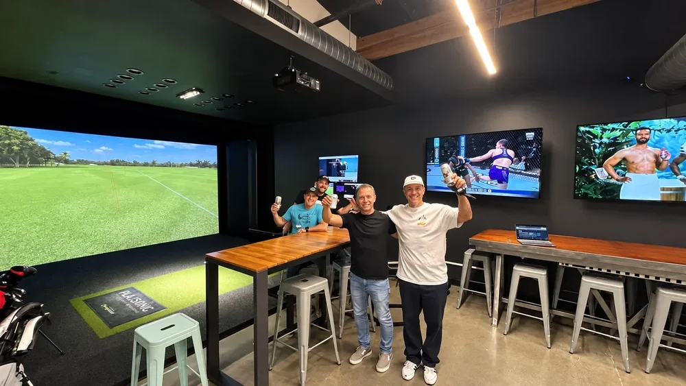 Friends celebrating in a simulator bay