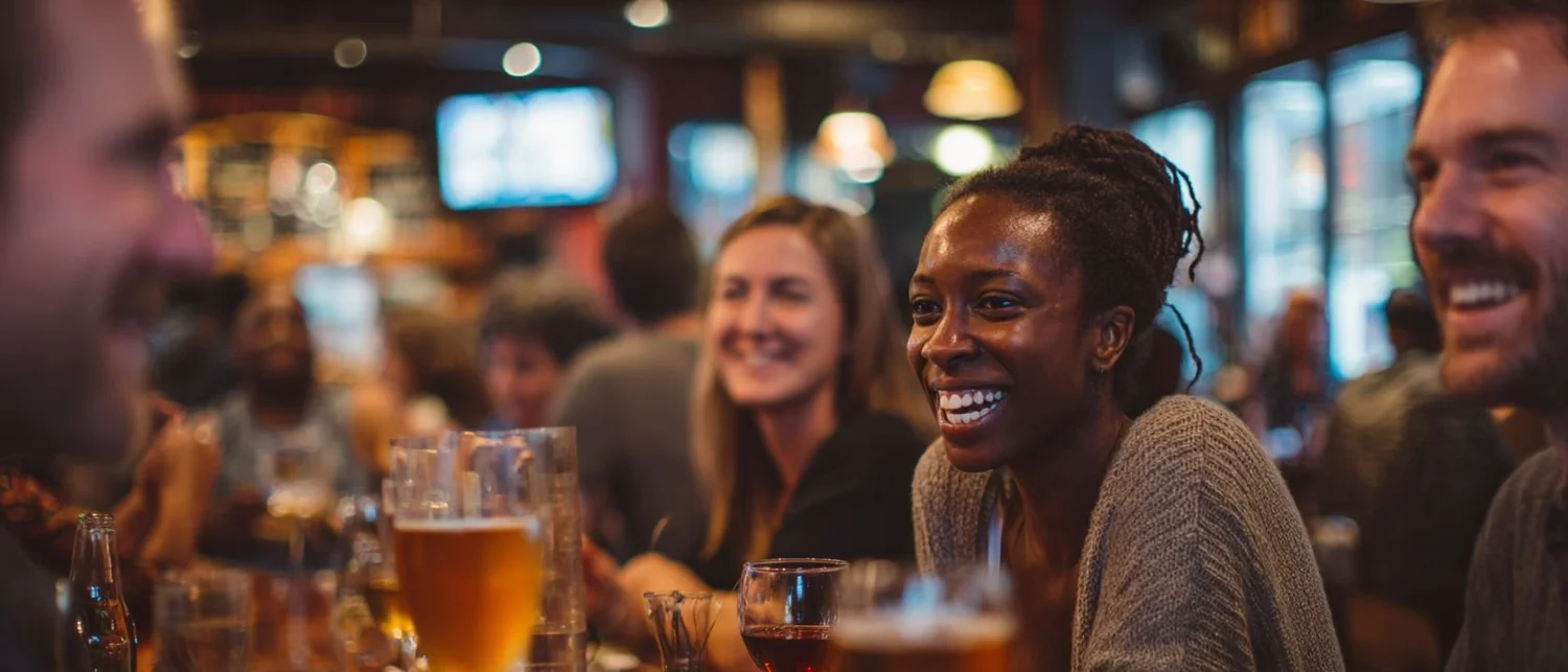 Group of friends around a table with board games and drinks in a private room