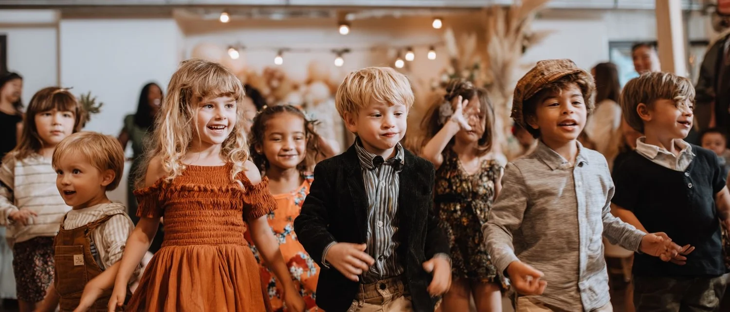 A festive private room at a restaurant set for a milestone celebration with balloons and place settings