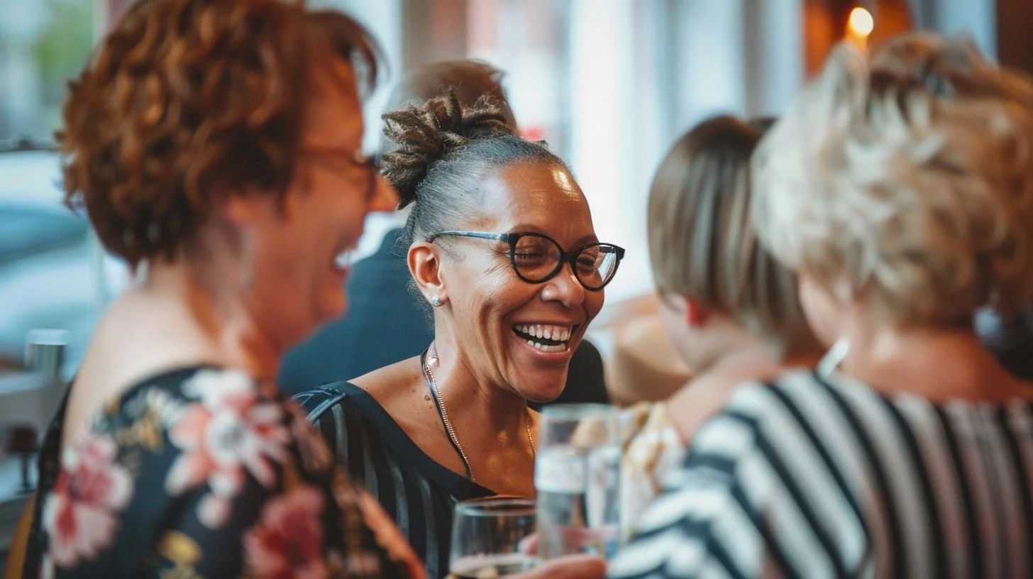 Small group gathered in a private room at a restaurant with warm lighting and conversation