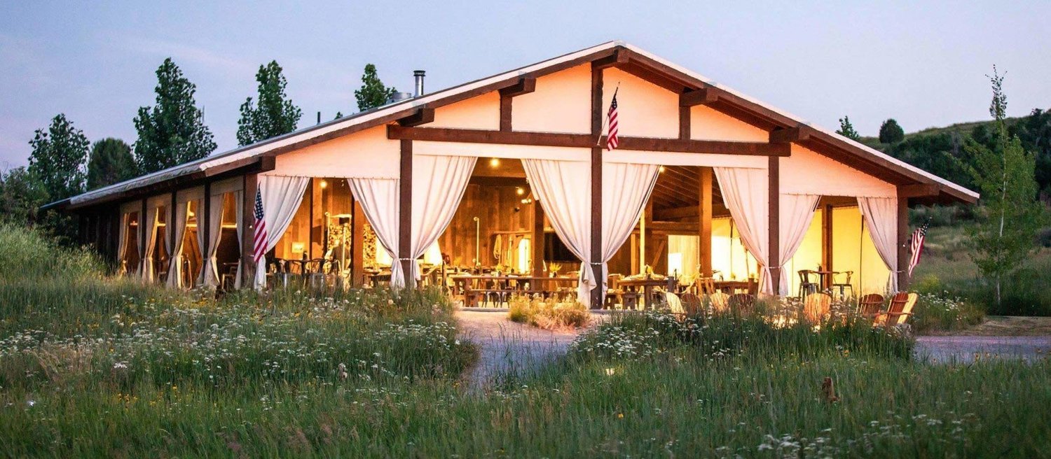 Corporate retreat group gathered outdoors at Conestoga Ranch with Bear Lake and mountain views