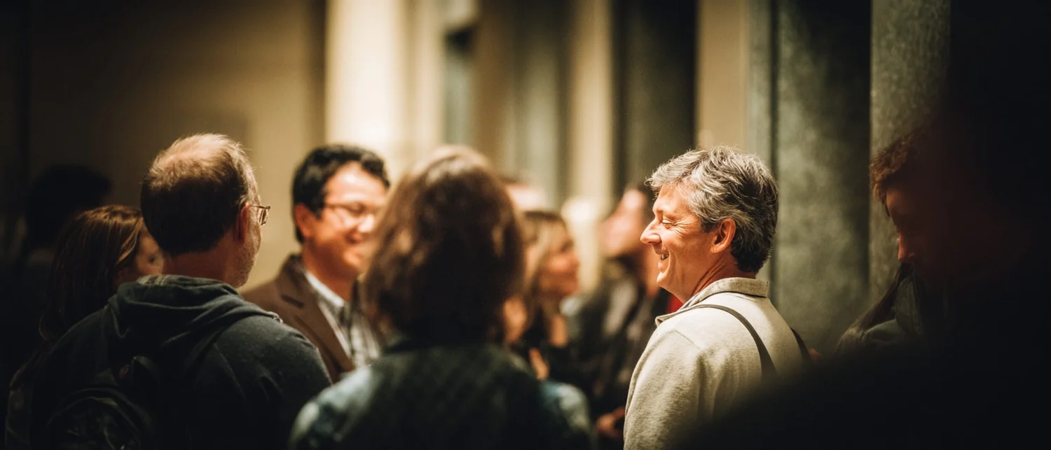 A nonprofit cocktail reception at a historic venue with guests networking in a warmly lit room