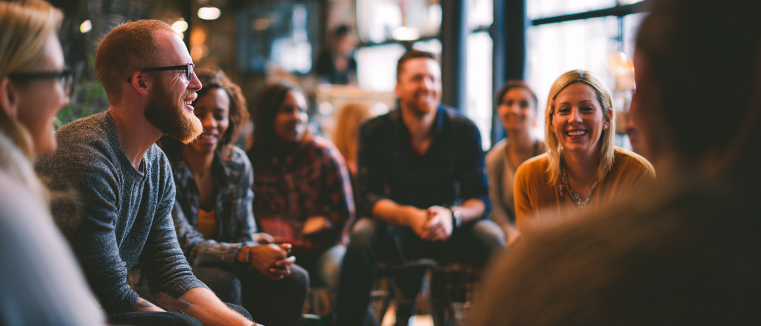 A lively private dinner party at a long table with guests laughing and wine being poured