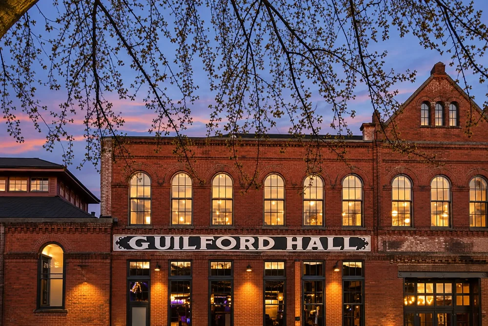 The Guilford Hall sign on the brick factory at twilight