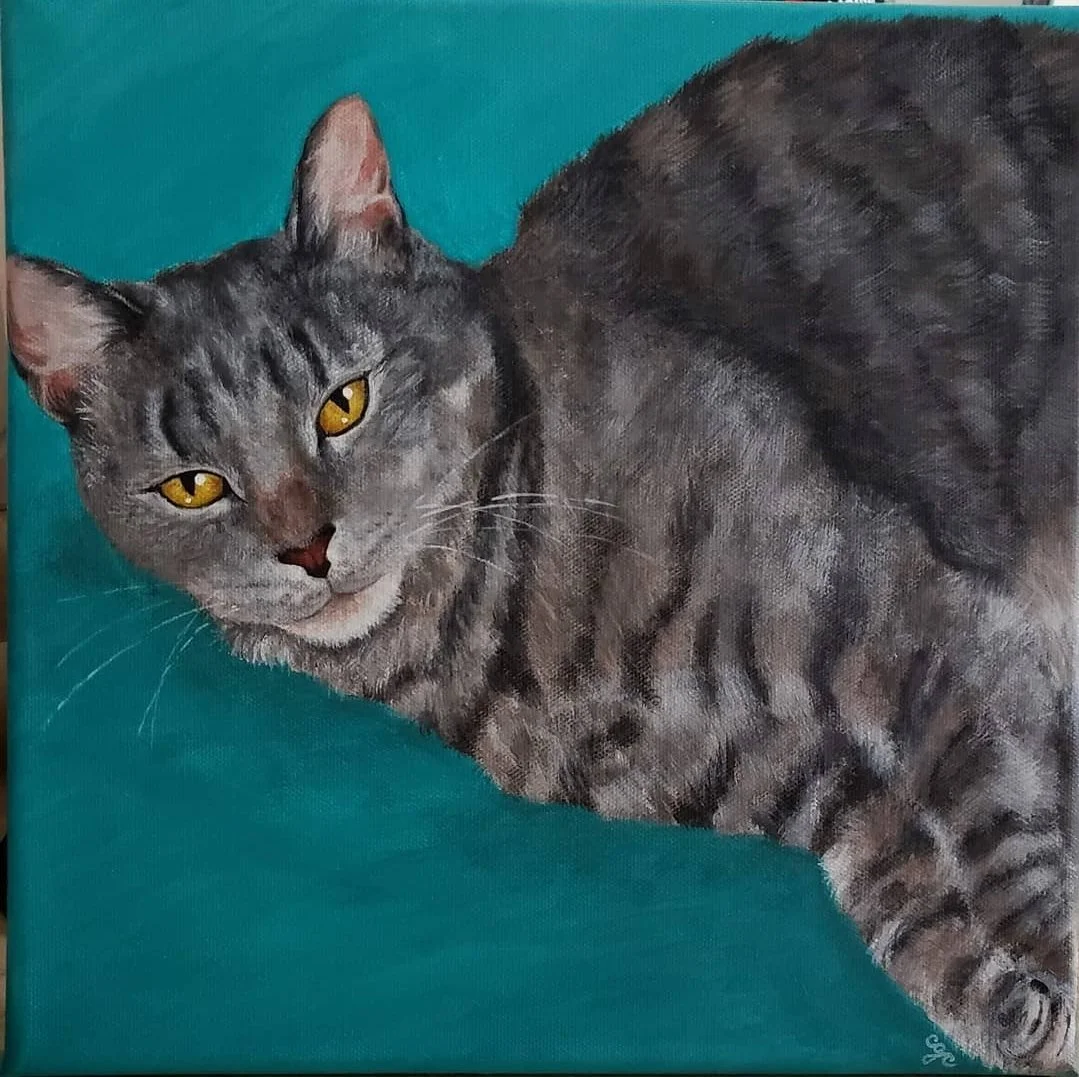 Painting of a gray tabby cat lying on a teal surface, looking at the viewer with yellow eyes.