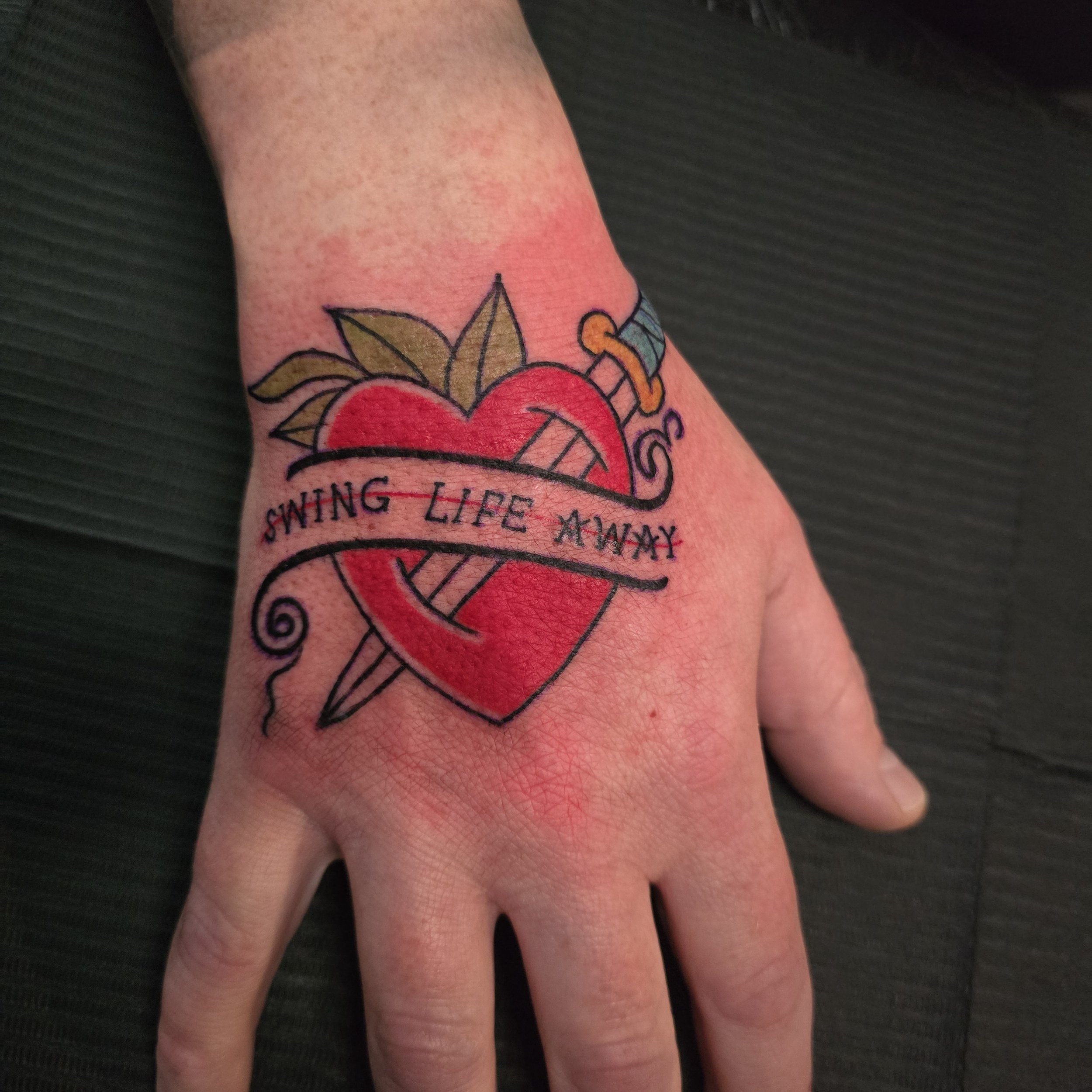 Traditional heart and dagger on the hand