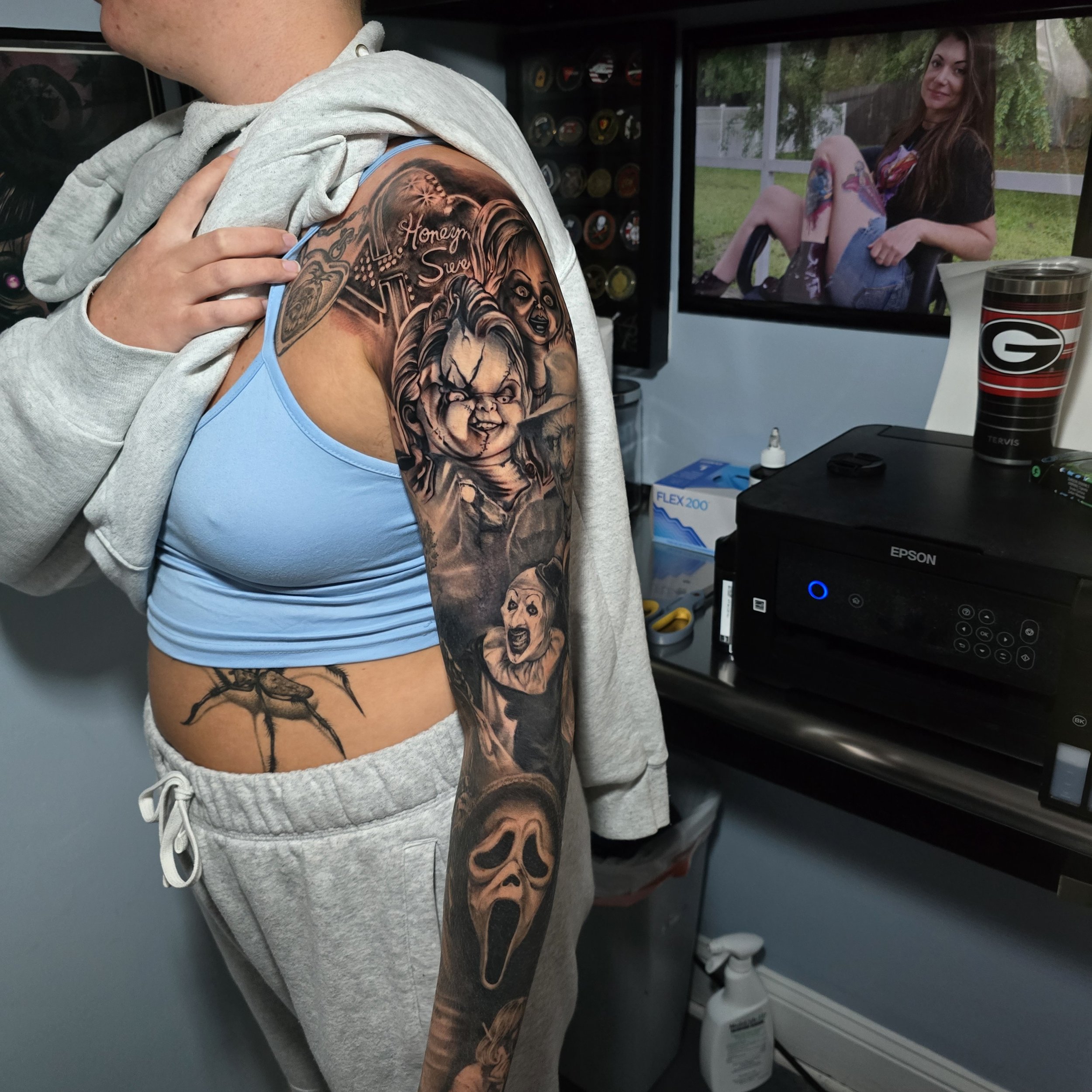 Horror sleeve in black and grey realism that includes characters from multiple movies.  Tiffany and Chucky, Art the Clown, Freddy Kruger, Ghostface, Michael Myers, Leather Face, and Jason are all represented.