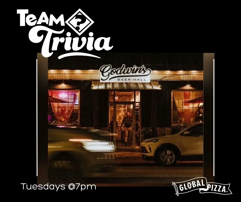 Sign advertising Tuesday Trivia Night, every Tuesday starting at 7 pm, with illuminated letters on a wooden background.